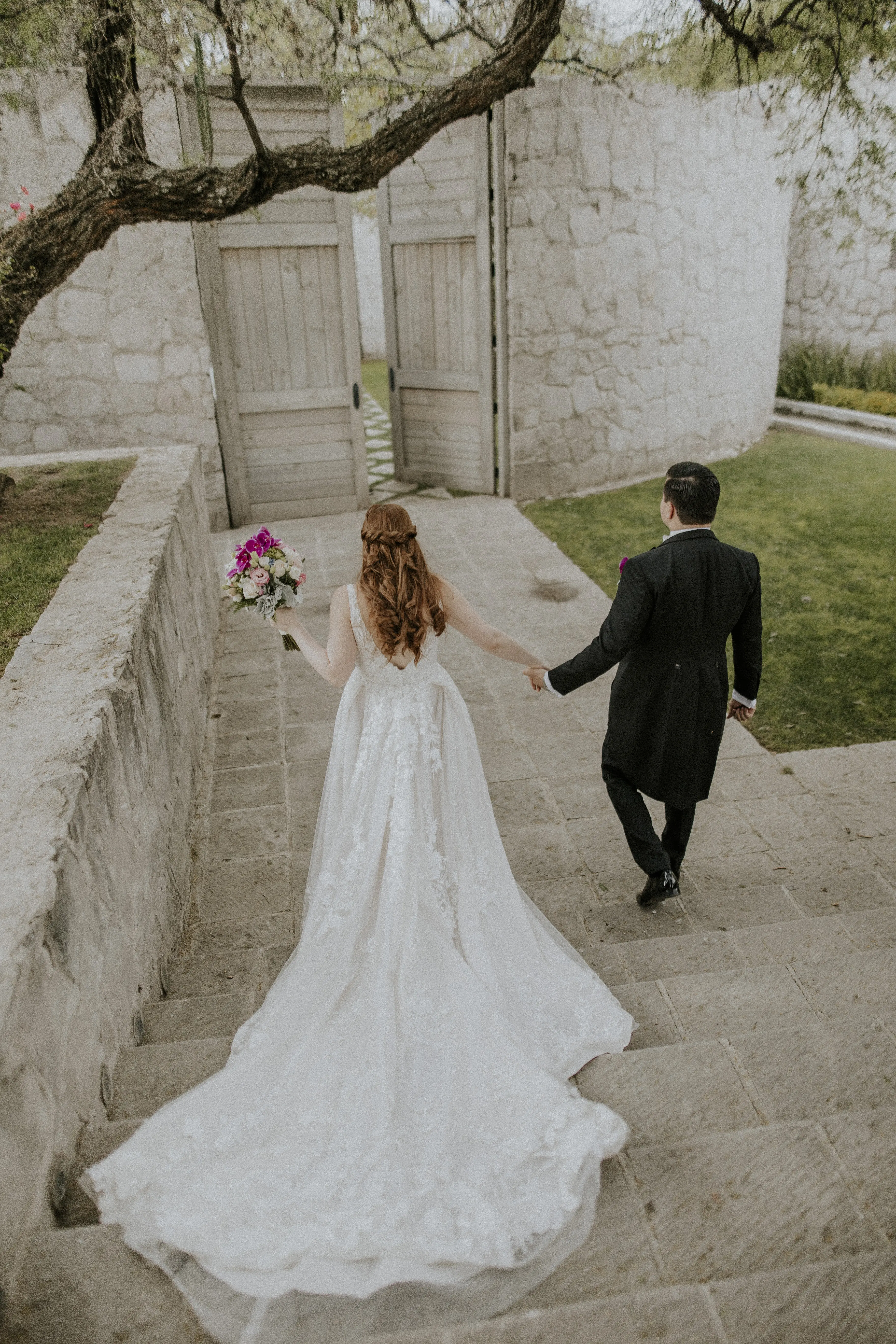 Bride Wearing Lace Wedding Dress Called Albany By Maggie Sottero Holding Hands With Groom