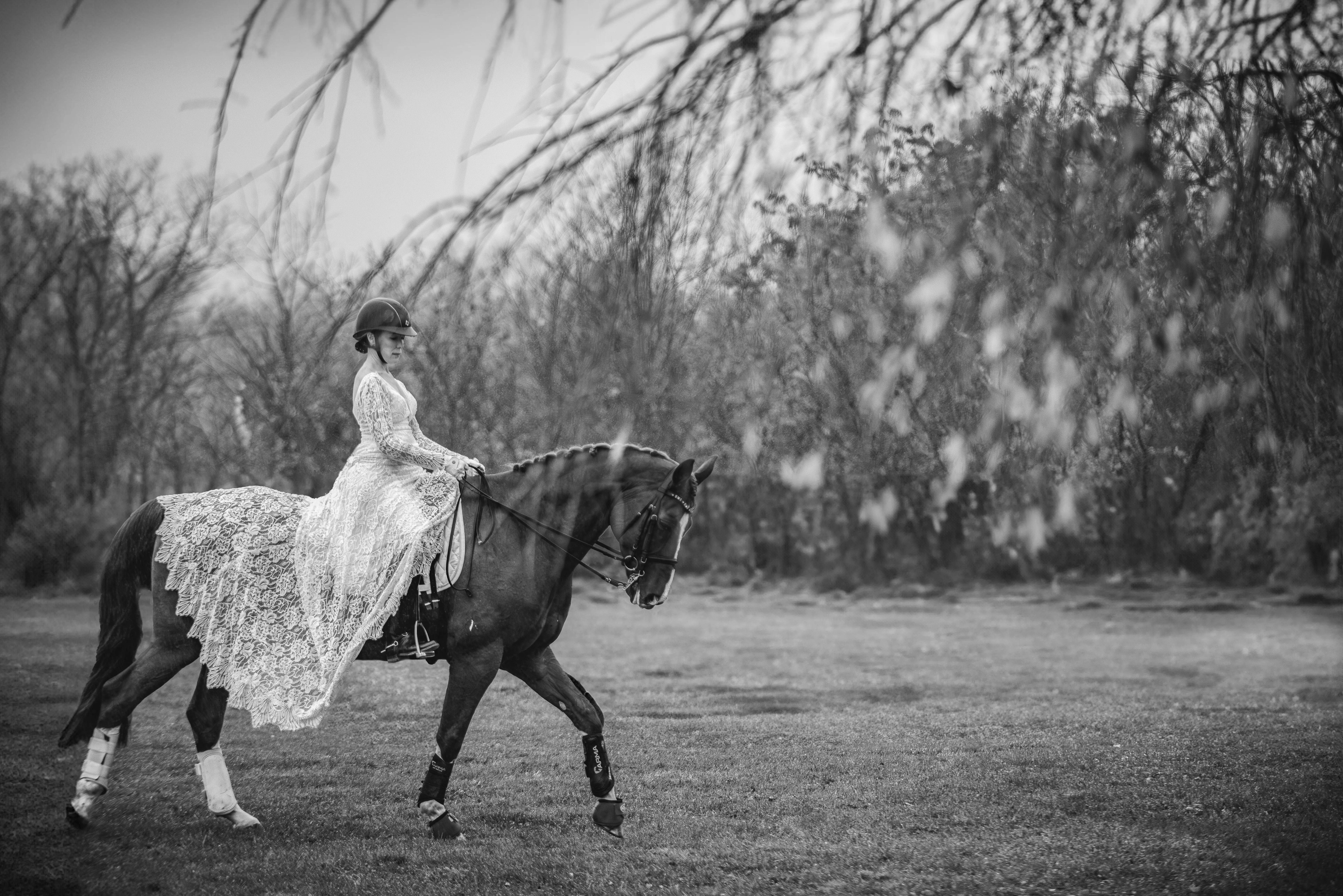 Bride wearing Drita wedding dress by Maggie Sottero riding a horse