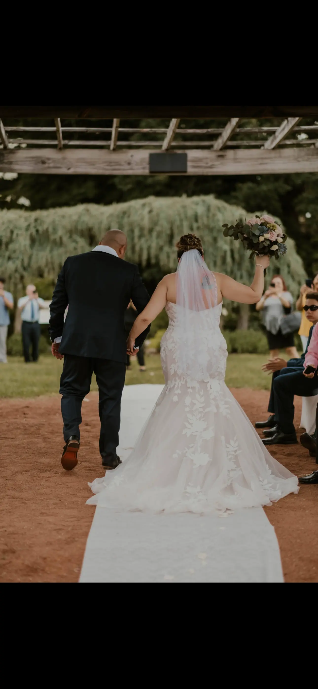 Groom Walking With Bride In A Mermaid Lace Wedding Dress Named Hattie By Rebecca Ingram