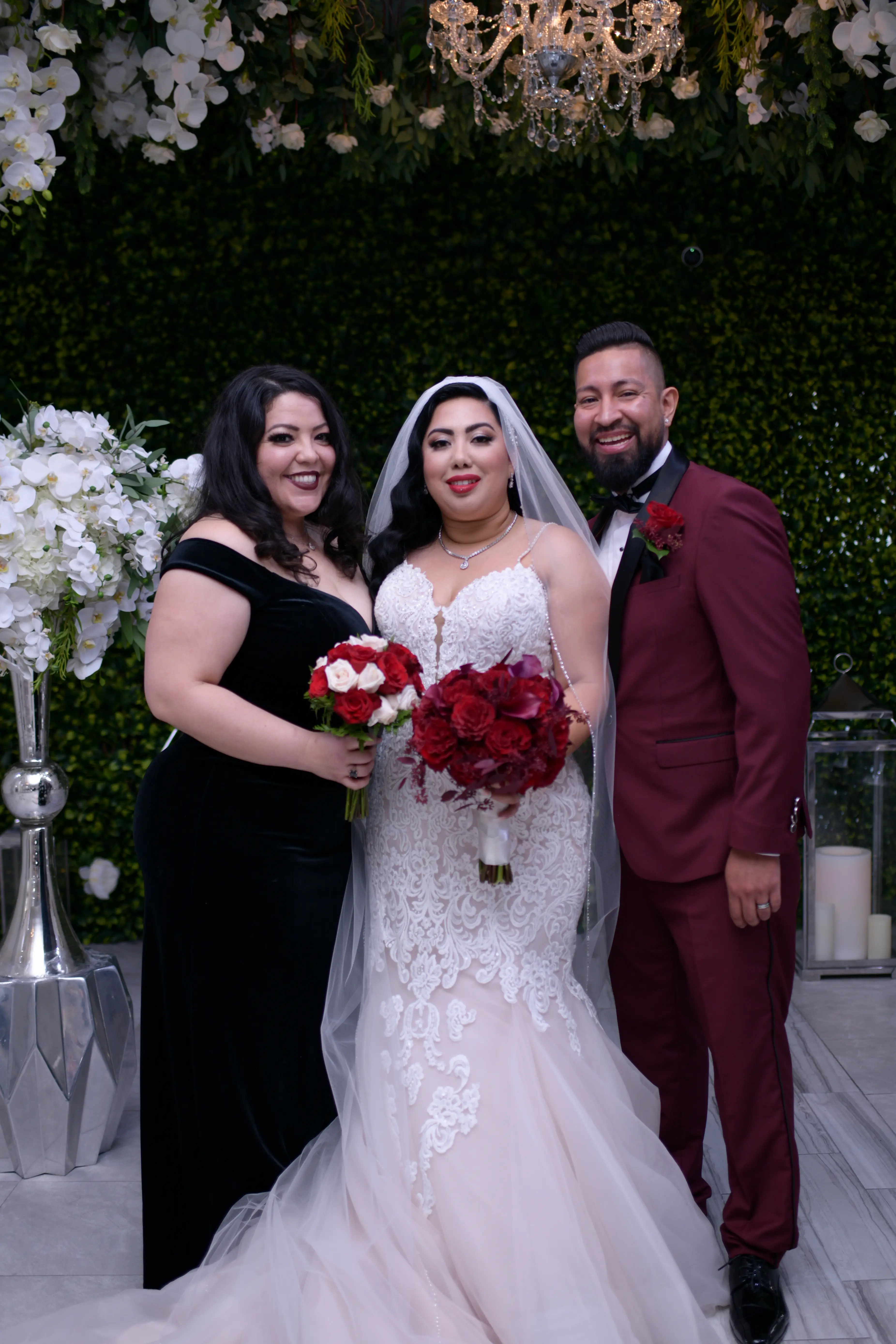 Groom and maid of honor stood with bride wearing wedding dress called Alistaire Lynette.