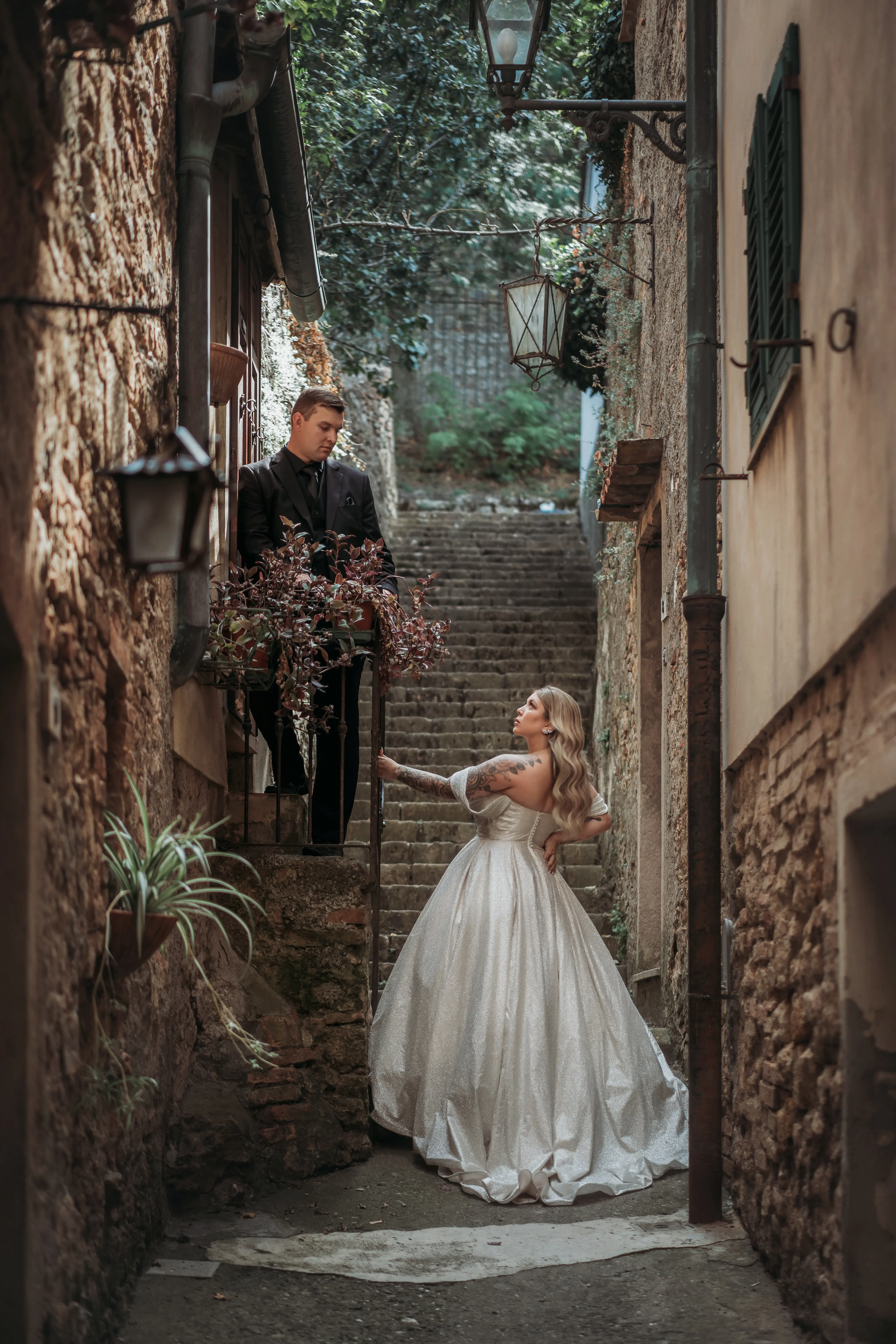 Bride wearing Anniston by Maggie Sottero with her husband on the steps