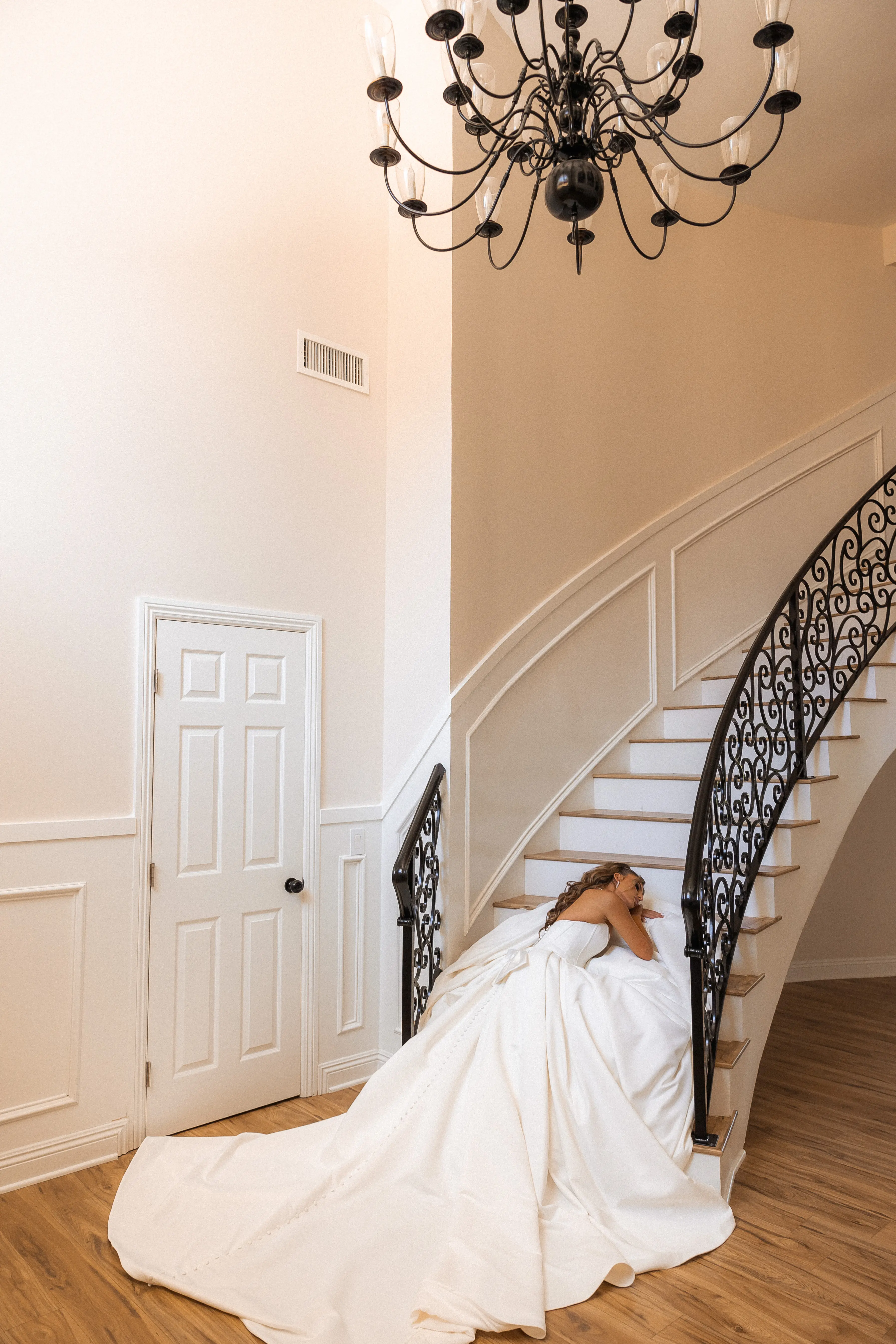 Bride wearing Derrick by Maggie Sottero laying on the steps