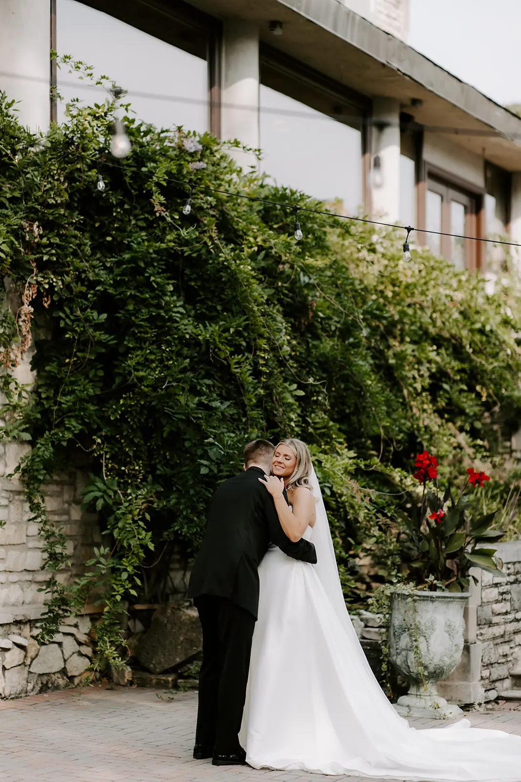 Bride Wearing Simple Aline Wedding Dress Called Aspen By Sottero And Midgley With Groom And Foliage In The Background