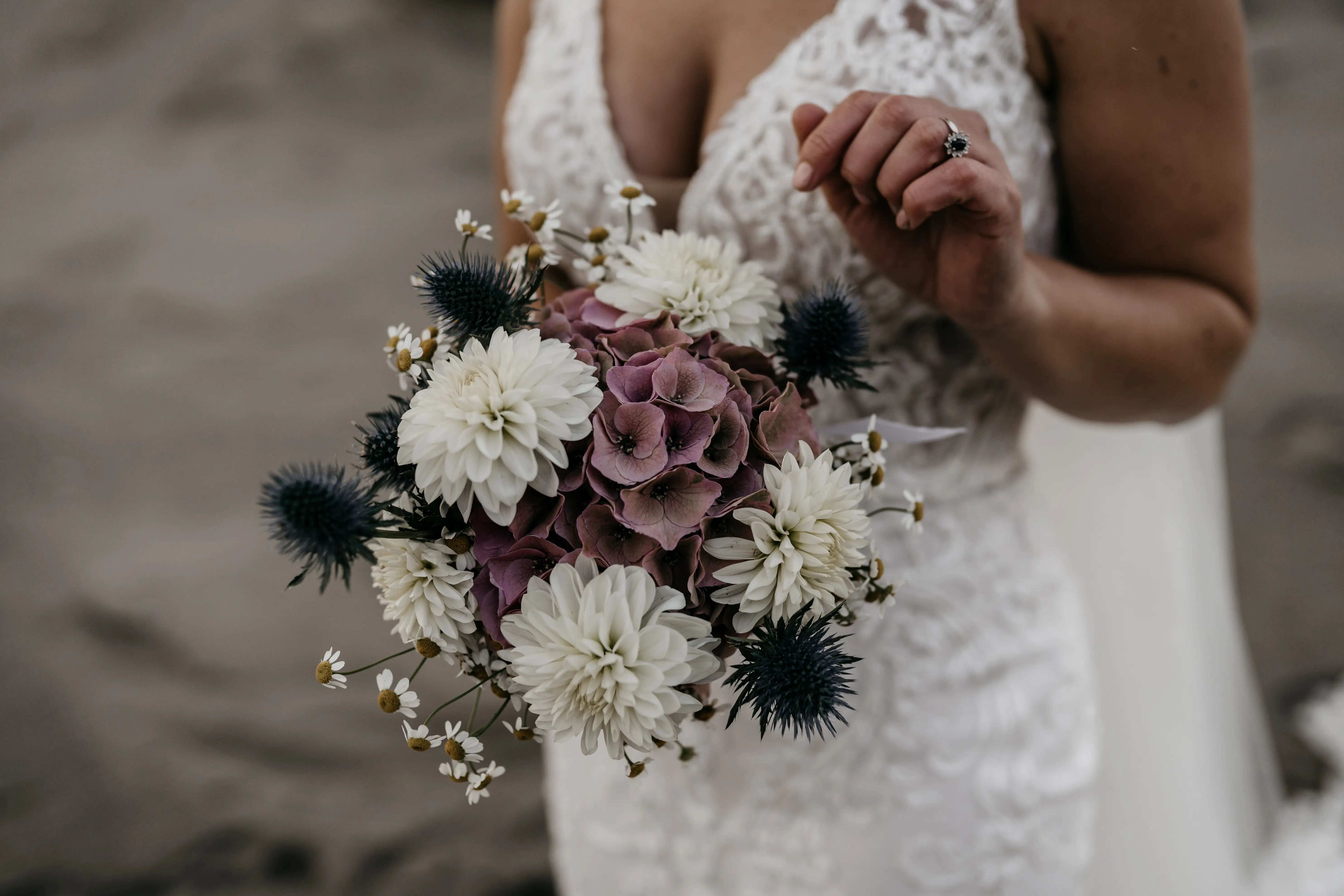 Bride Wearing Lace Fit-And-Flare Wedding Dress Called Hamilton By Sottero And Midgley Holding a Bouquet