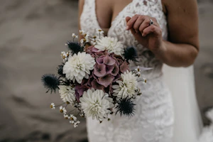 Bride Wearing Lace Fit-And-Flare Wedding Dress Called Hamilton By Sottero And Midgley Holding a Bouquet