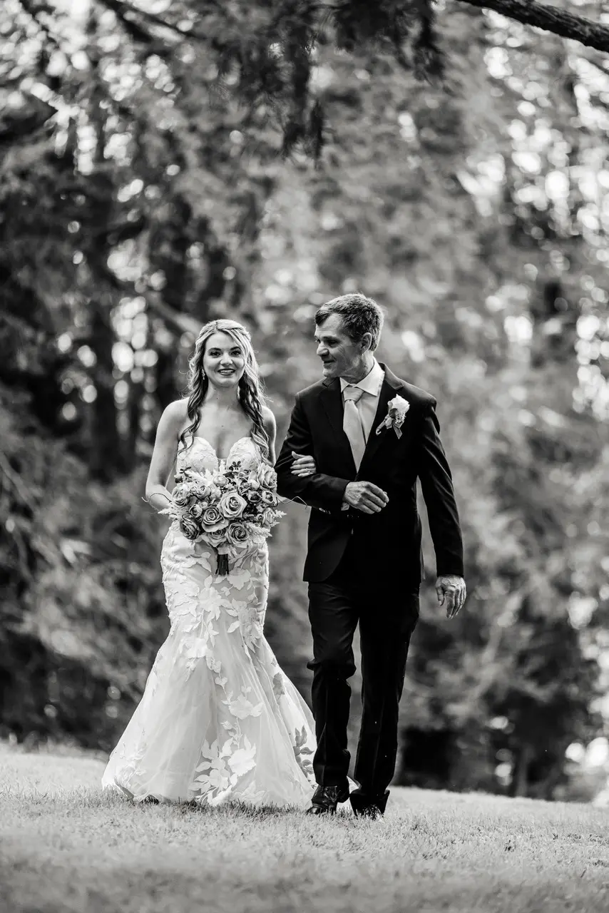 Bride wearing Hattie Marie by Rebecca Ingram arm in arm with her husband