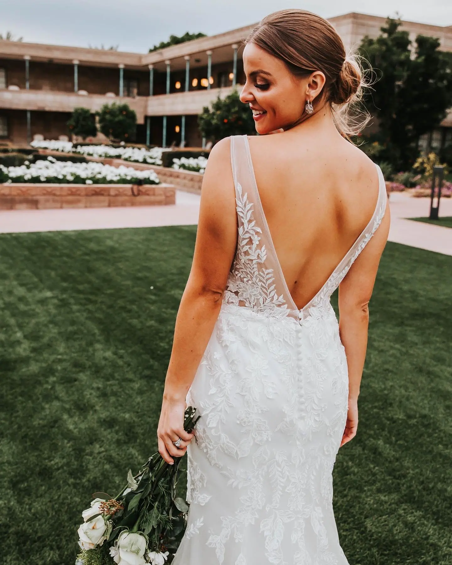 Bride Posing with Bouquet In Garden-Inspired Lace Wedding Dress Named Greenley By Maggie Sottero