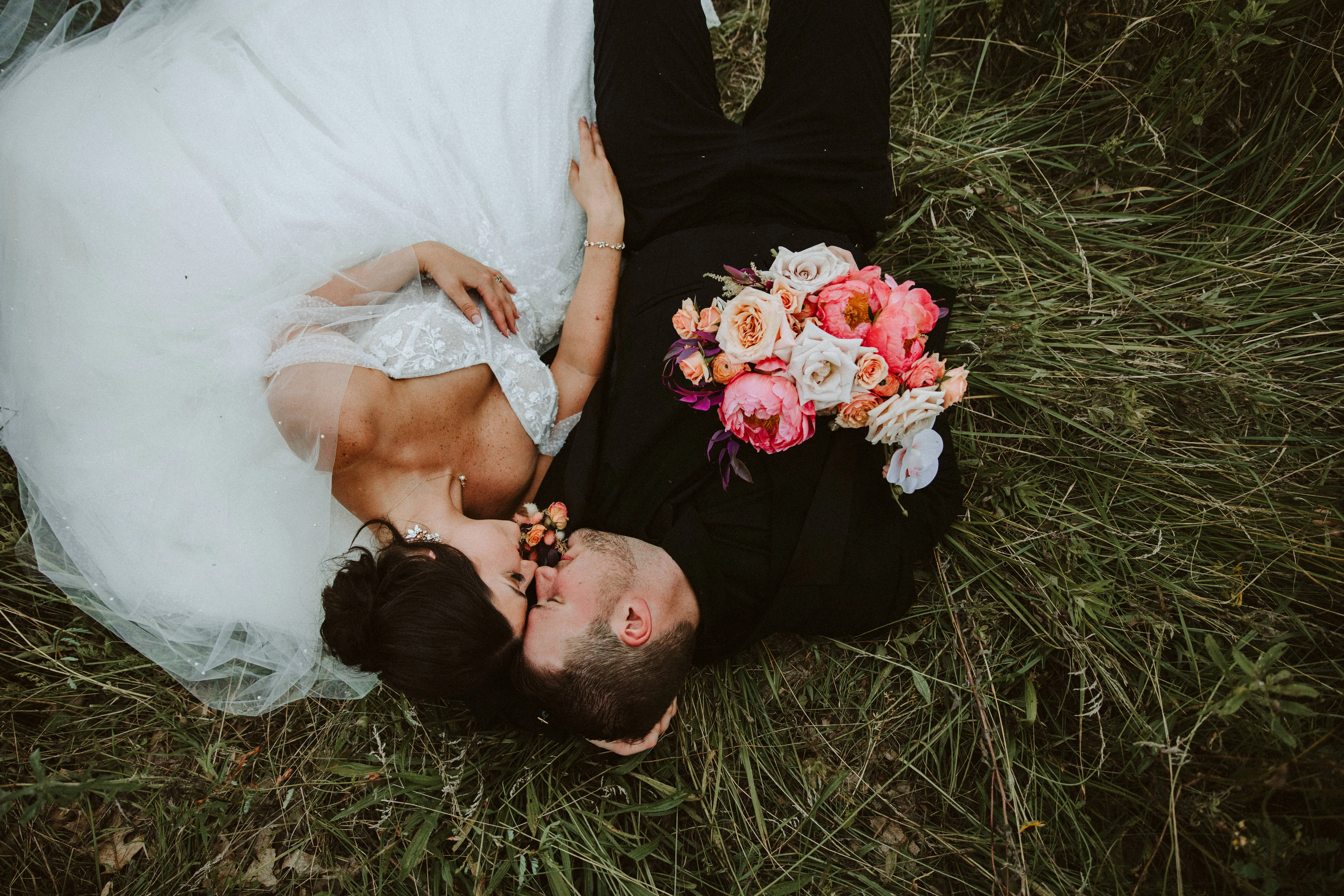Bride Wearing Sparkly Ballgown Wedding Dress Called Shasha By Sottero And Midgley With Groom Laying In A Field