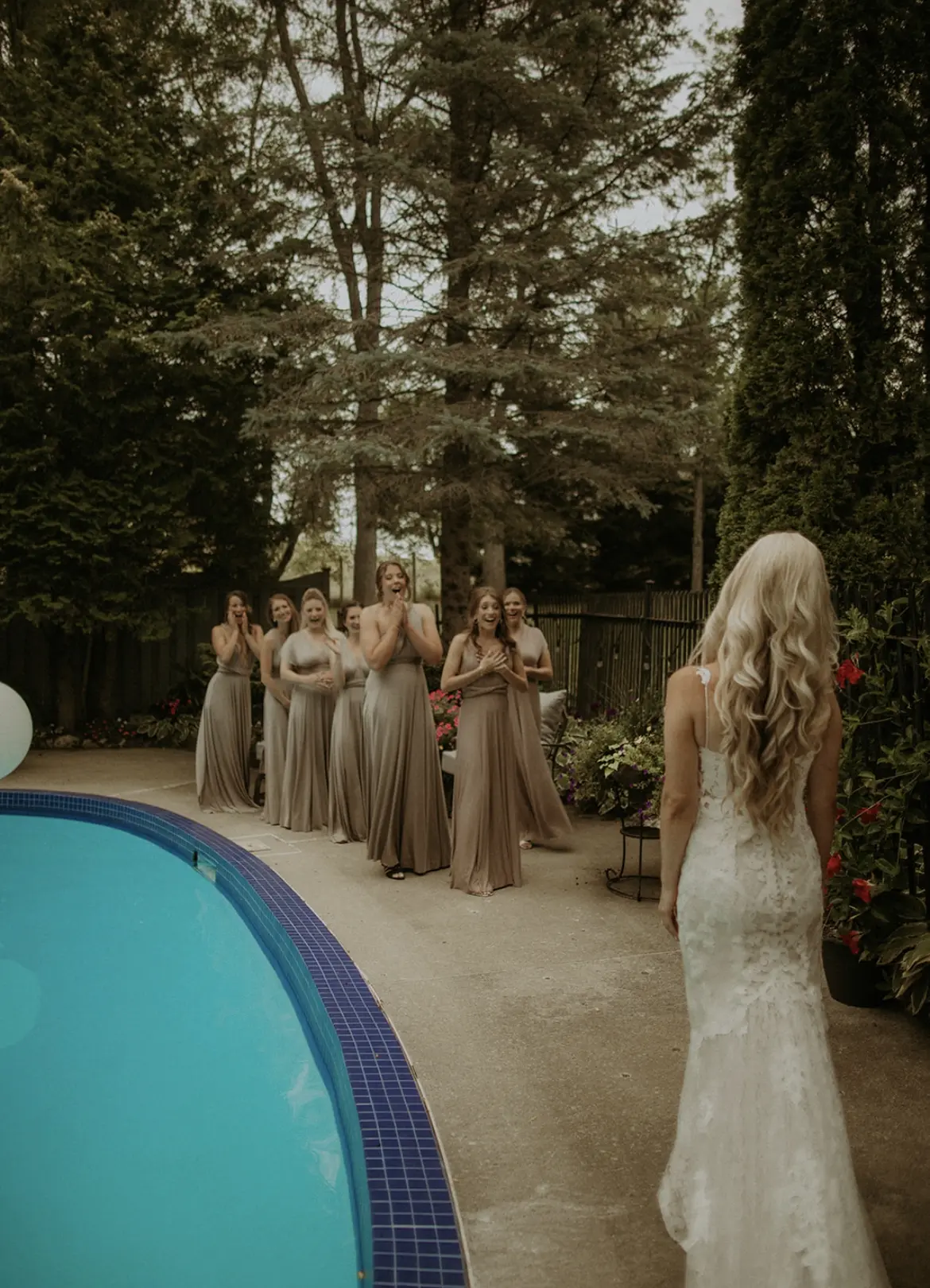 Bride wearing Lace Fit-and-Flare Wedding Dress called Tuscany Lynette by Maggie Sottero and her first look with her bridesmaids