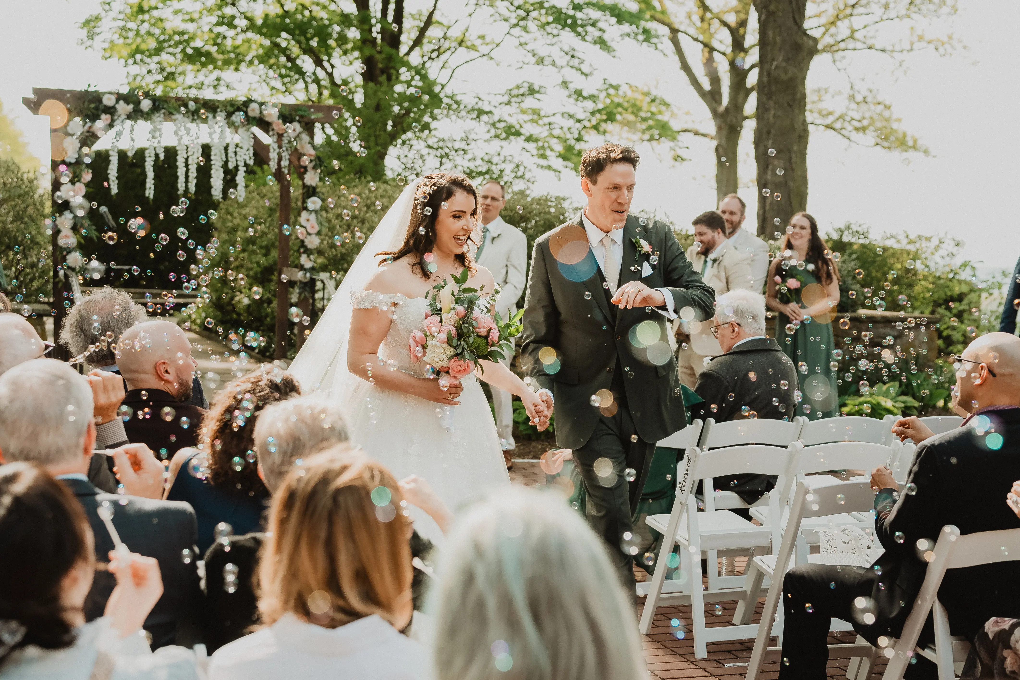 Bride wearing Mason by Sottero and Midgley exiting their ceremony