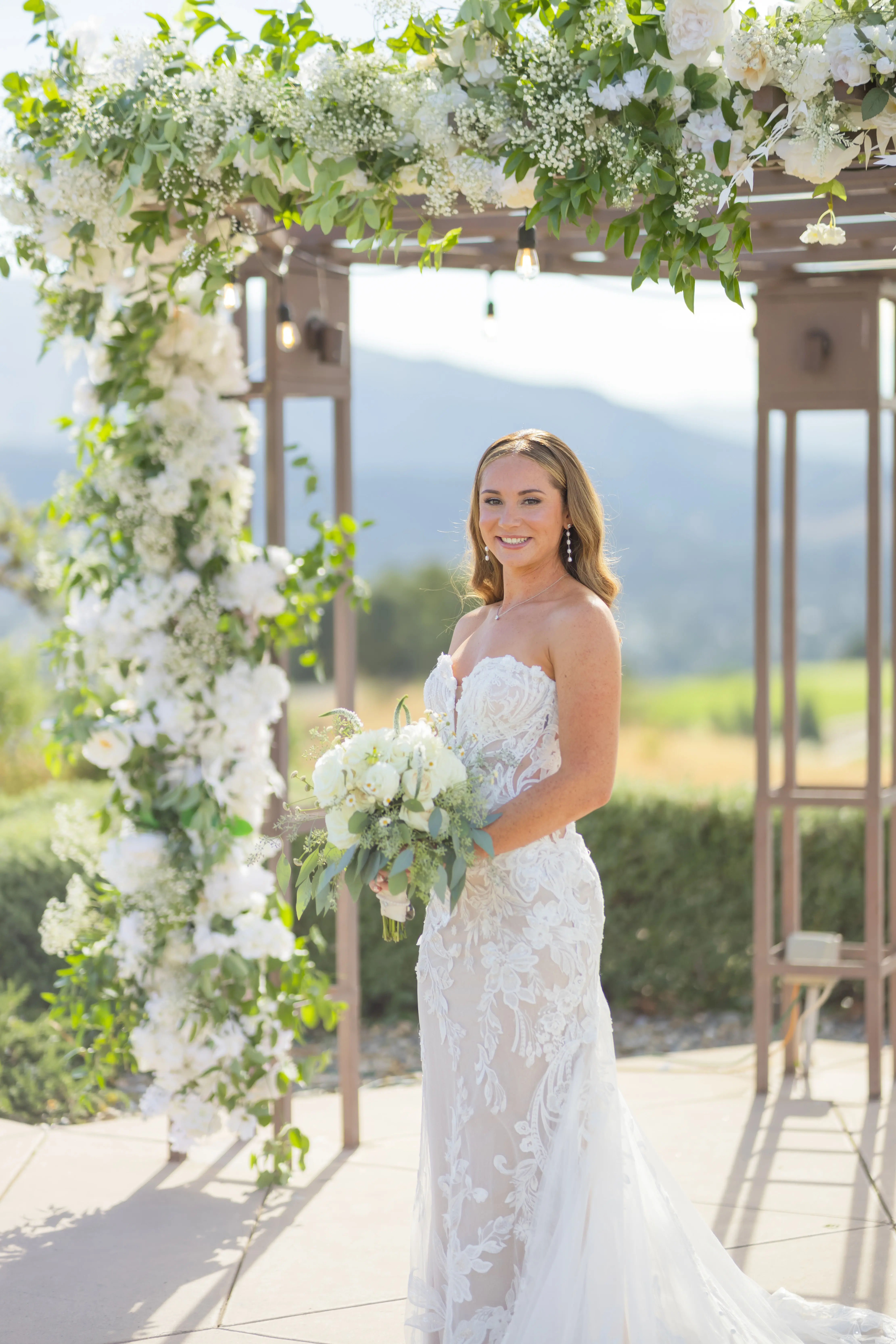 Bride Wearing Lace Fit-n-flare Wedding Dress Called Nyjah By Sottero And Midgley Holding White Floral Bouquet