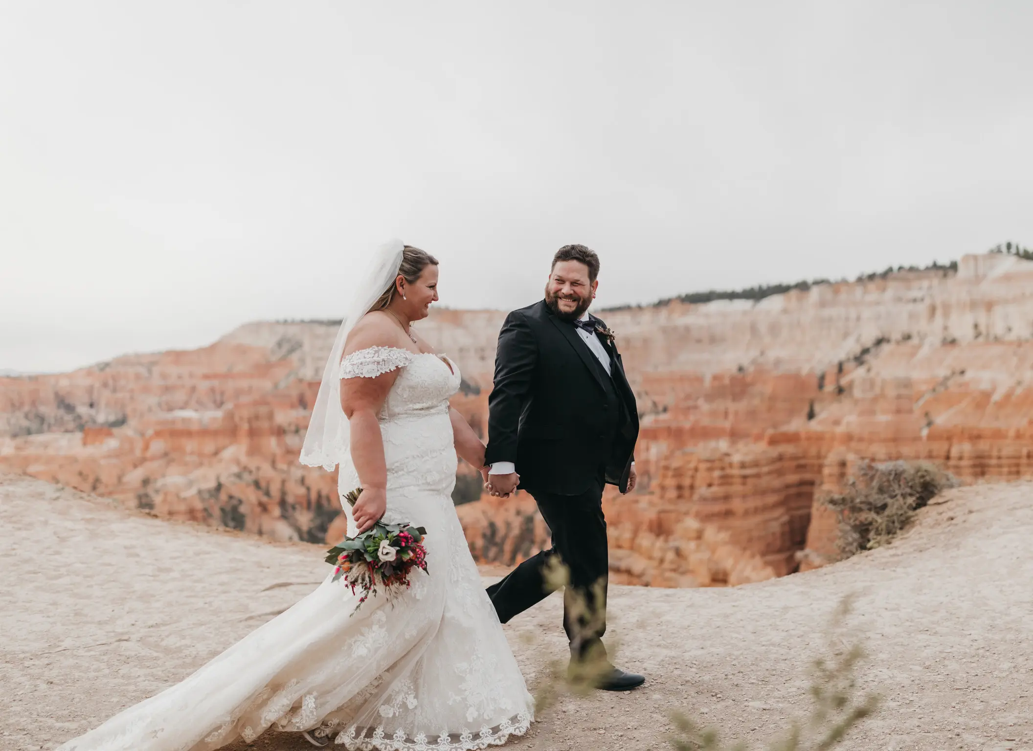 bride with groom in corset back fit and flare wedding dress