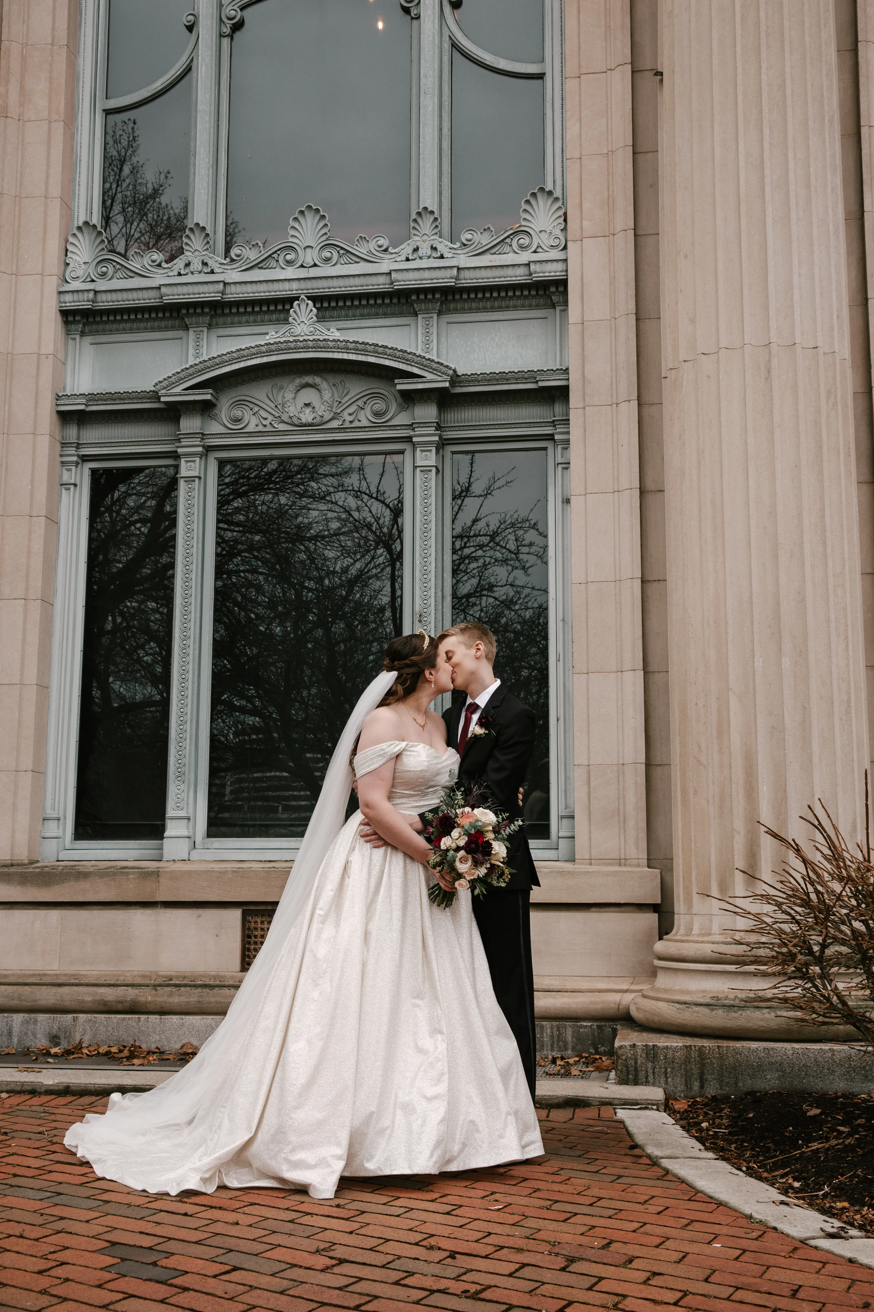 Groom Kissing Bride in Wedding Dress With Sparkles Named Anniston By Maggie Sottero