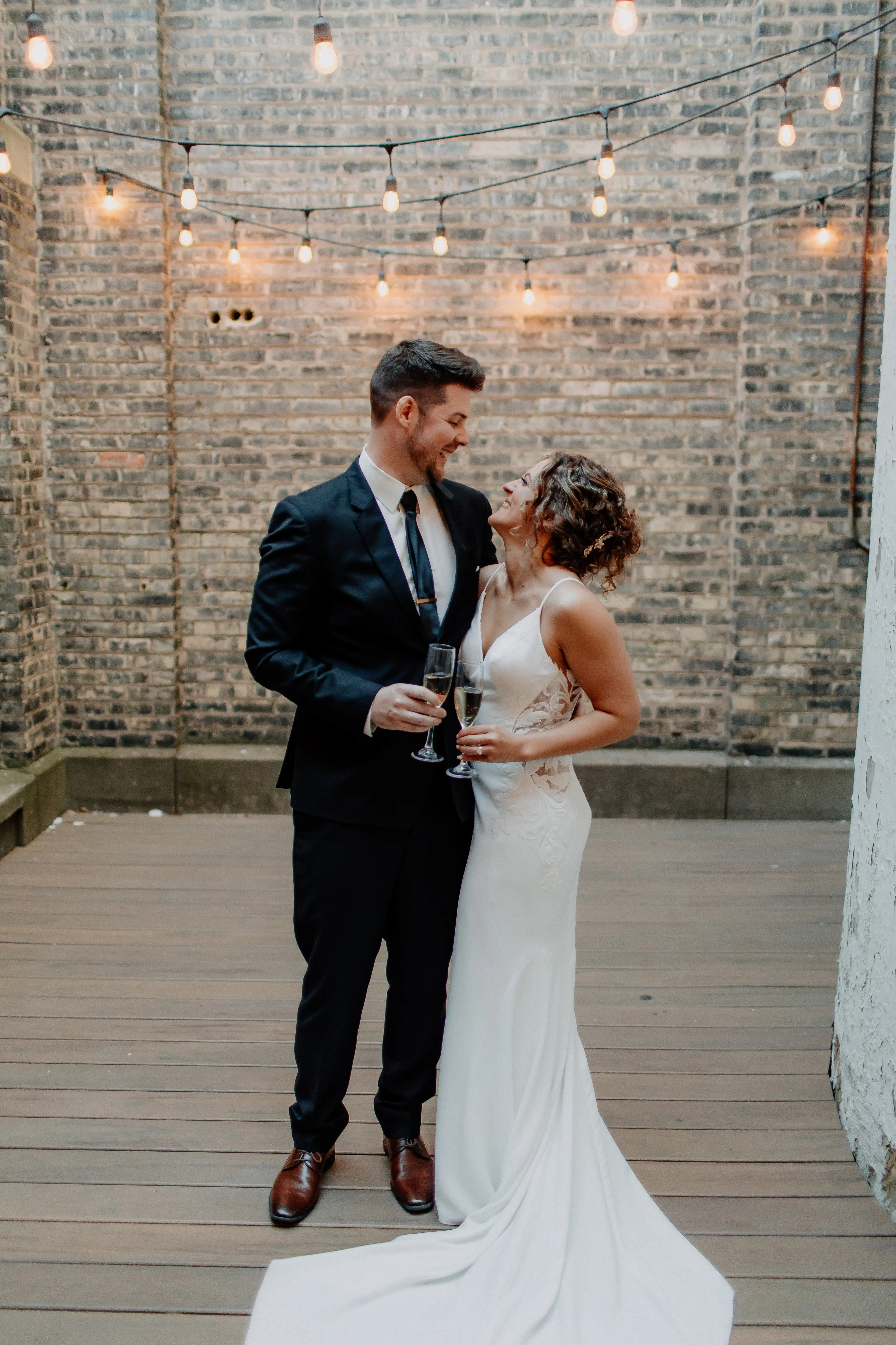 Bride wearing Dionne by Rebecca Ingram laughing with her husband