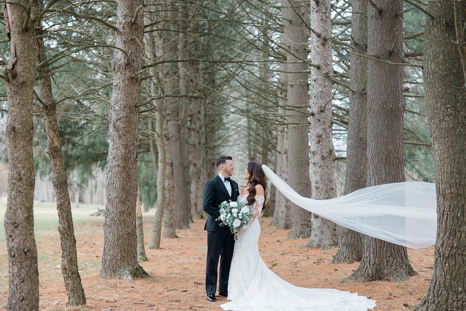 Bride Wearing Dress Called Fiona By Maggie Sottero And Groom Standing By Trees