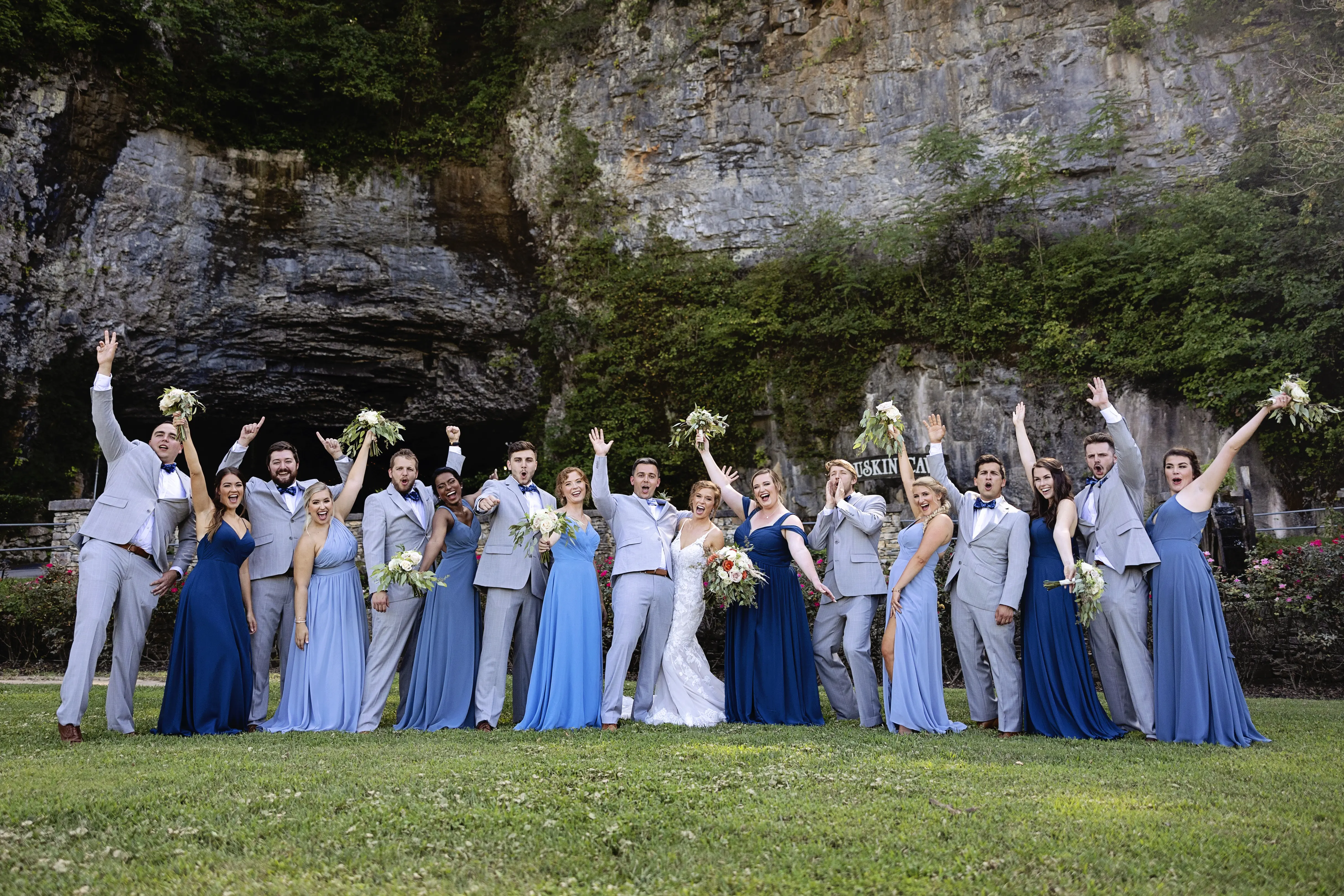 Bride In Sexy Lace Wedding Dress Called Giana By Maggie Sottero With Bridesmaids In Blue And Groomsmen in Gray
