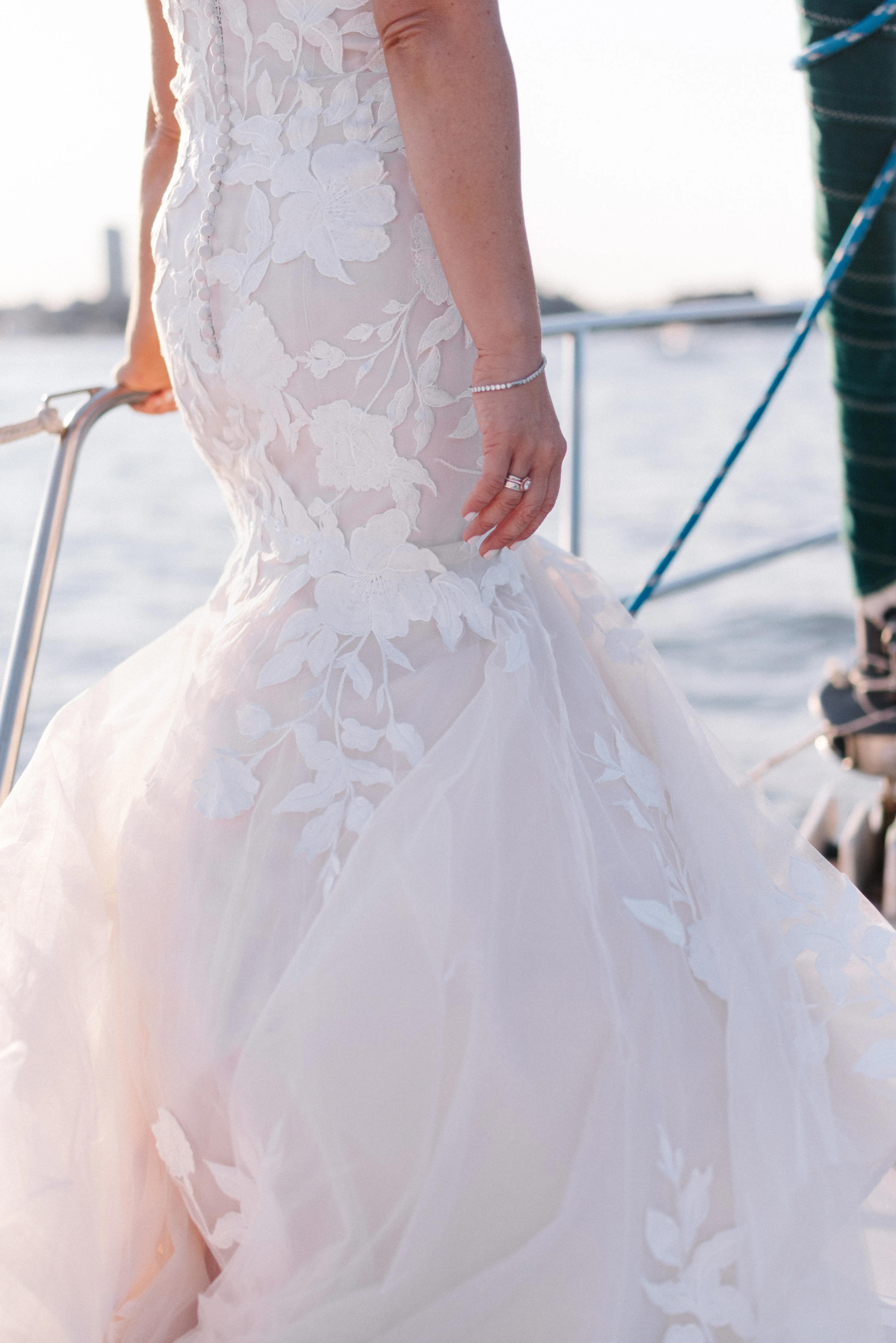 Bride wearing strapless mermaid wedding dress with plunging V-neck.
