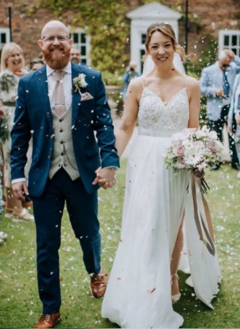 Bride wearing Lorraine by Rebecca Ingram and exiting her ceremony with her husband