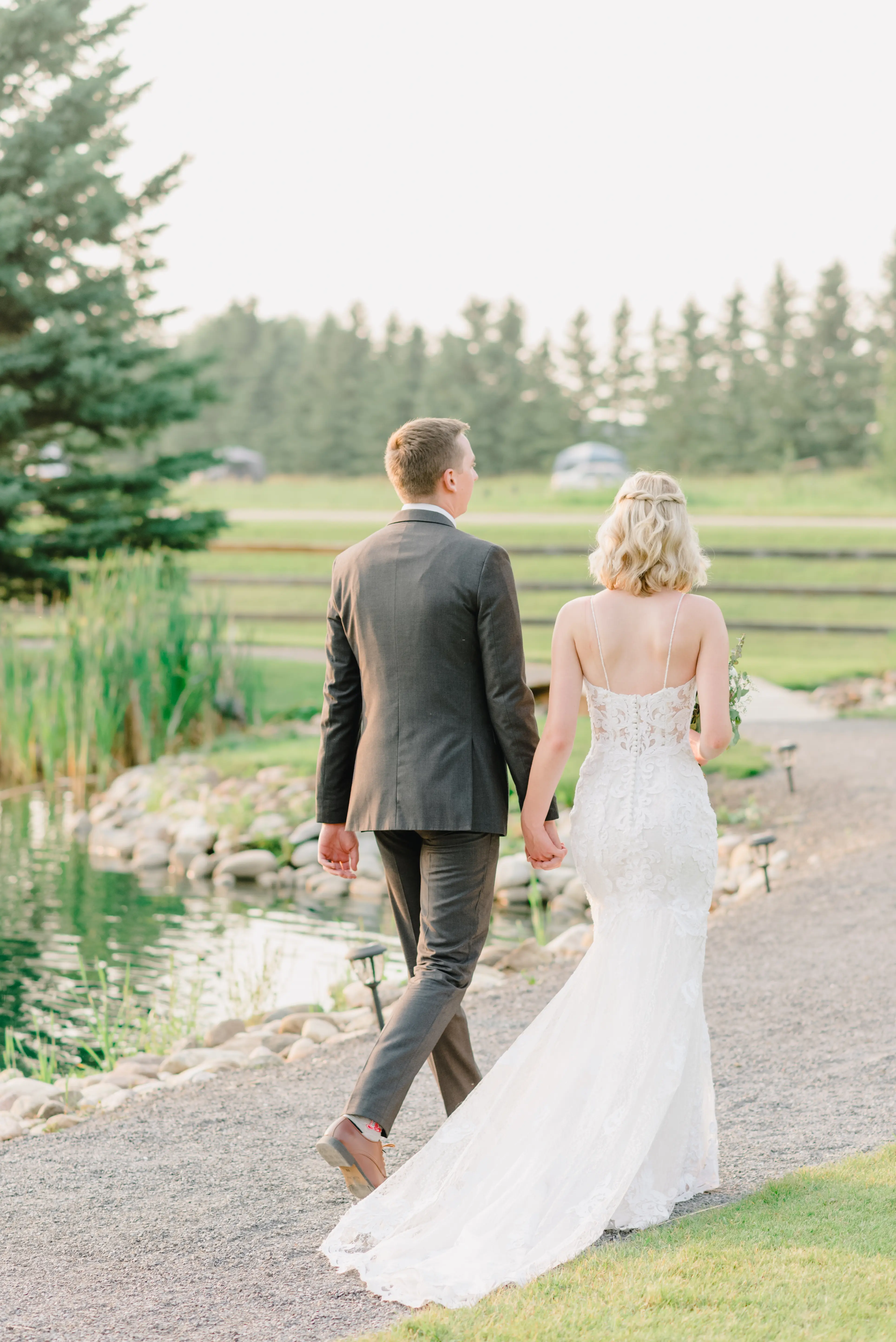 Bride with groom wearing lace sheath wedding dress