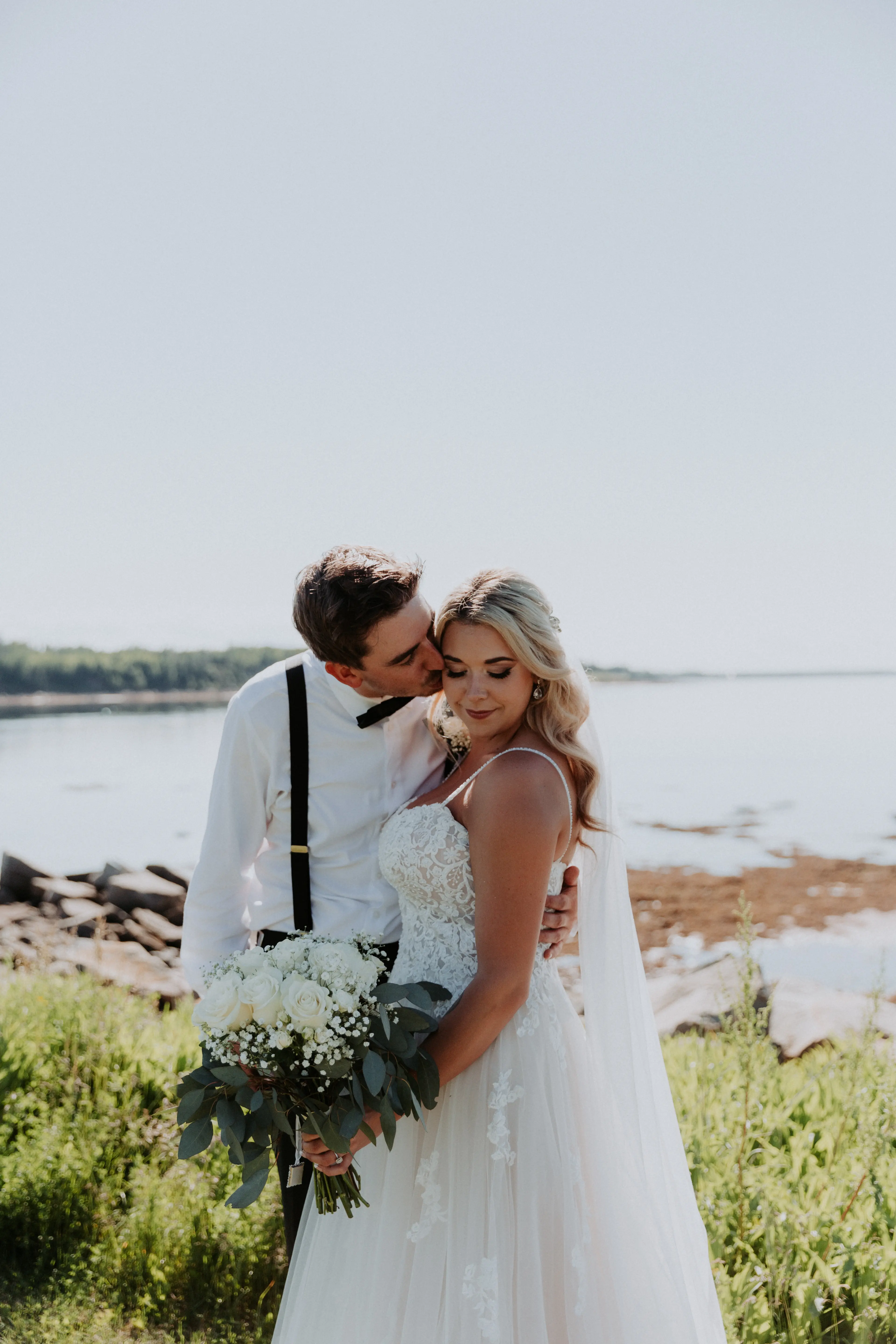 Groom with Bride in Flattering A-Line Spaghetti Strap Wedding Dress with Romantic Lace Called Marisol by Rebecca Ingram