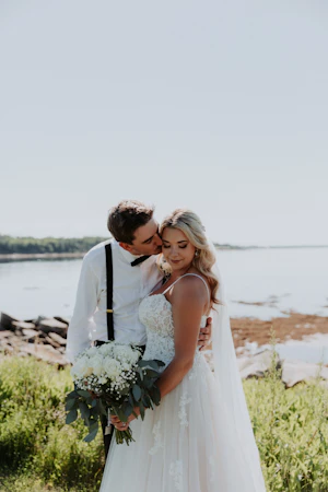 Groom with Bride in Flattering A-Line Spaghetti Strap Wedding Dress with Romantic Lace Called Marisol by Rebecca Ingram