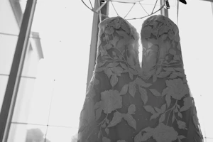 White Wedding Dress Named Hattie By Rebecca Ingram On A Hanger