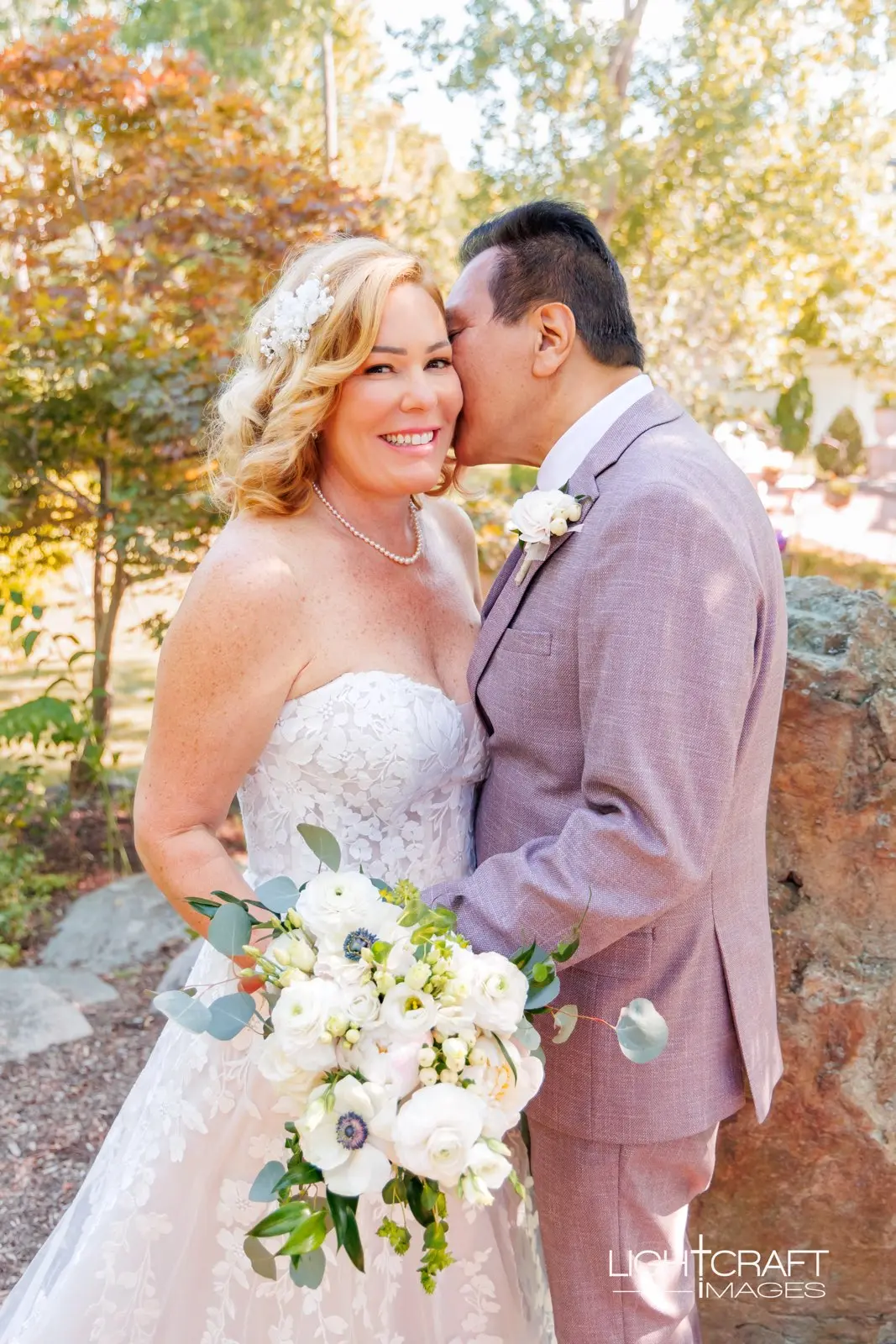 Bride wearing Demetria by Maggie Sottero being kissed by her husband