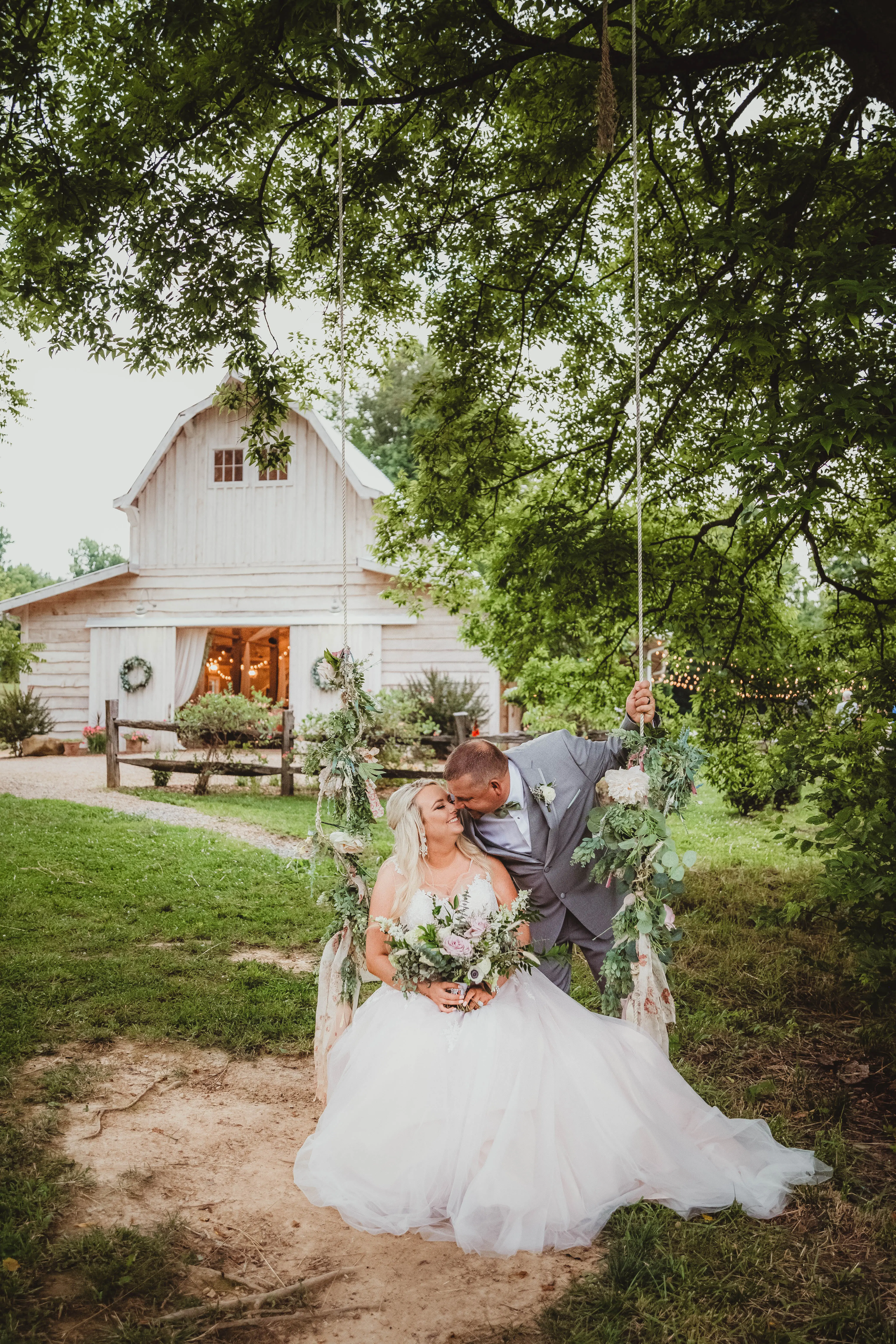 Groom and Bride at an Outdoor Wedding Wearing Lace Ballgown Wedding Dress Called Olivia by Rebecca Ingram