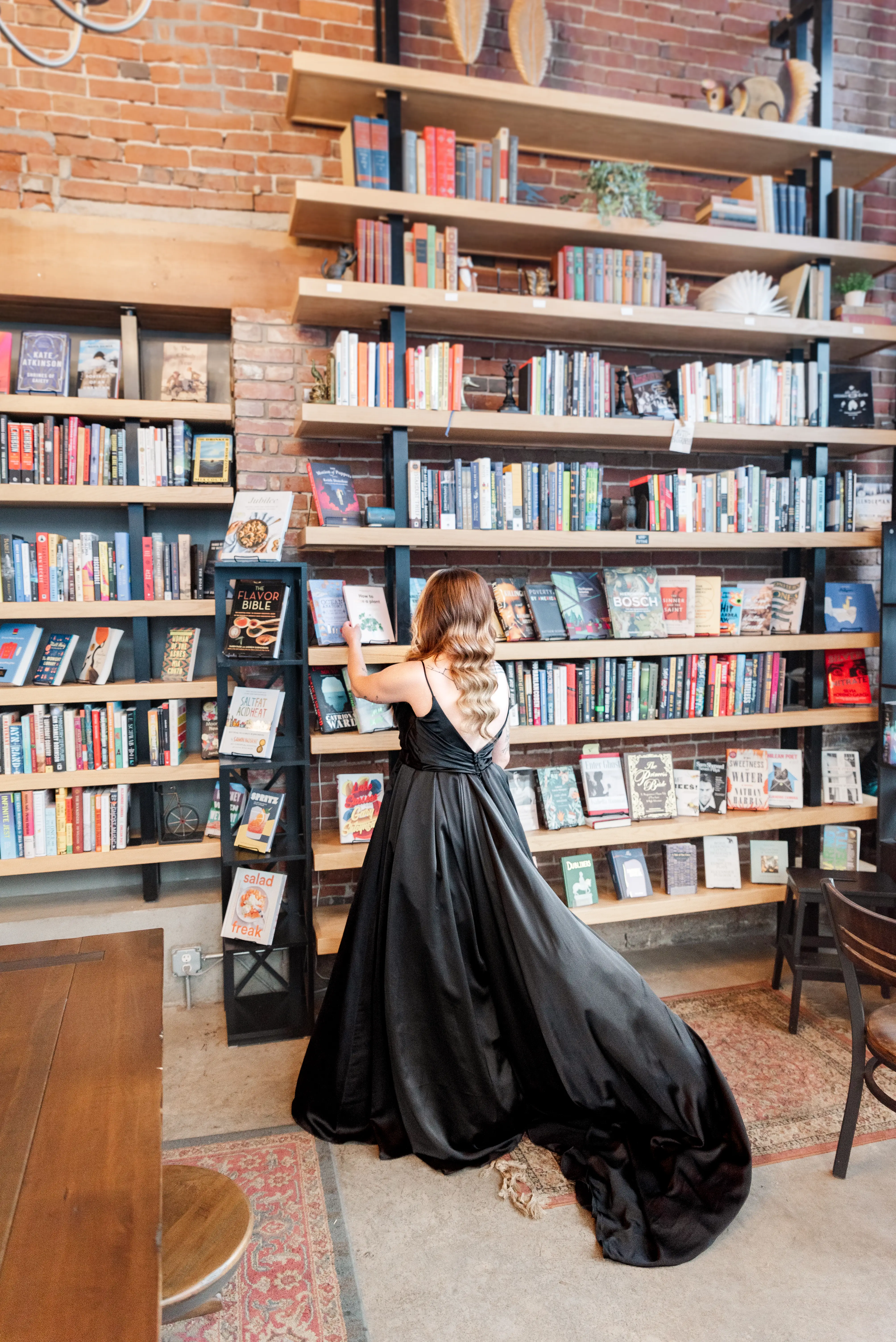 Bride wearing Scarlet wedding dress by Maggie Sottero in a book store