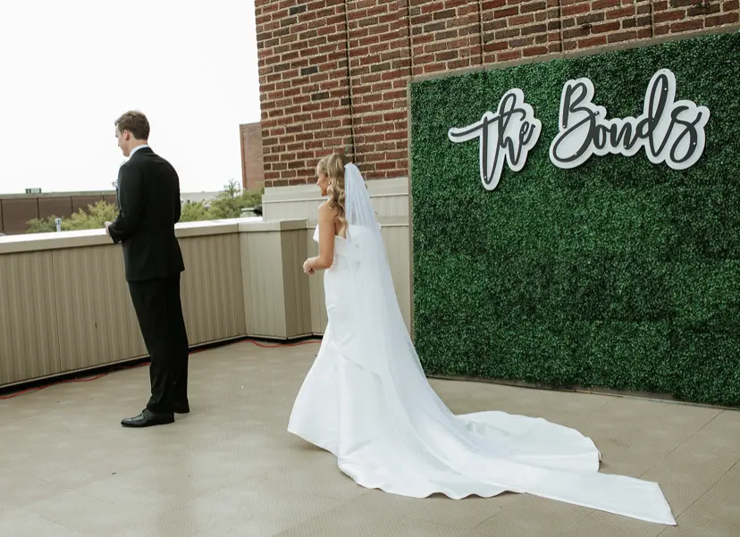 Bride with groom wearing unique strapless wedding dress