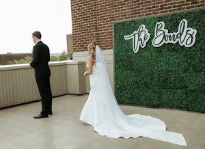 Bride with groom wearing unique strapless wedding dress