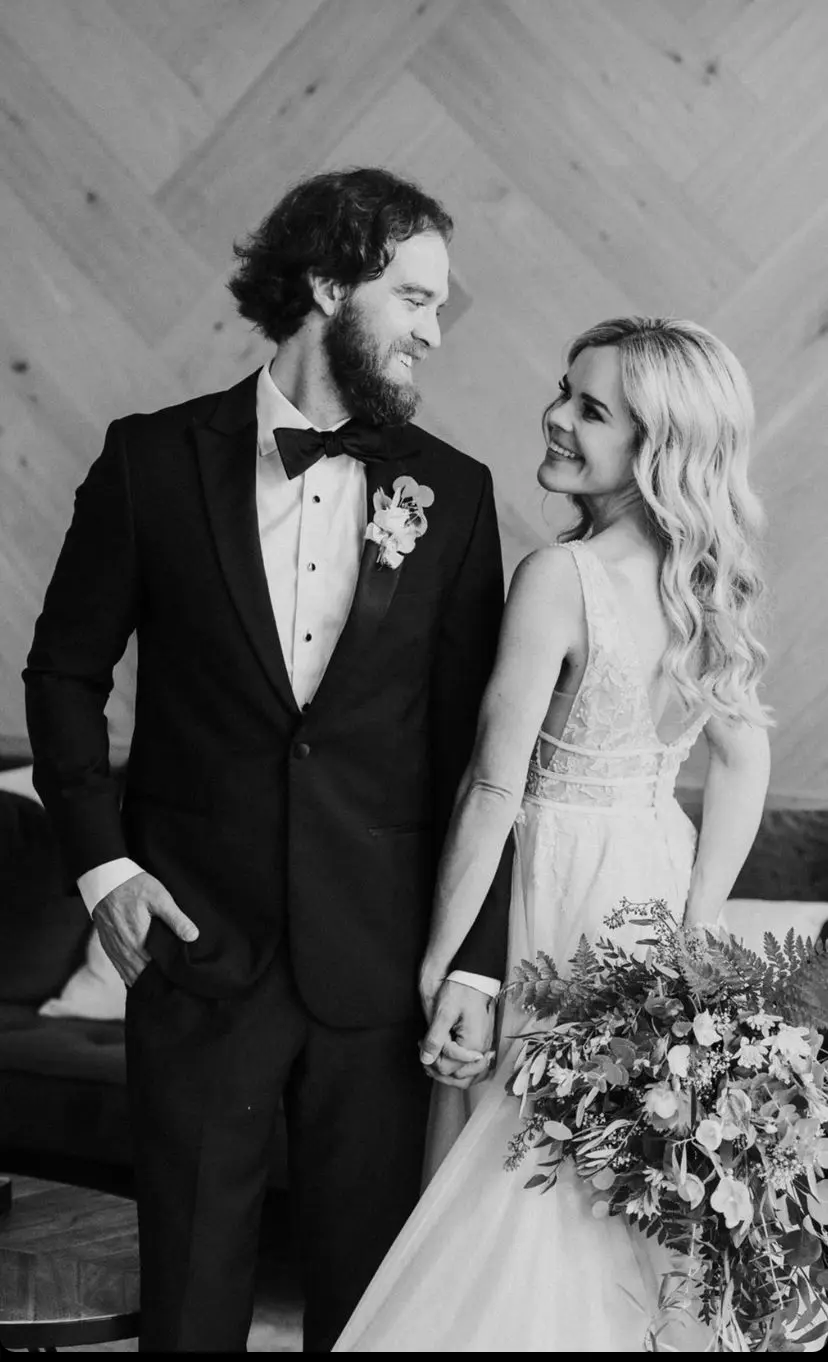 Groom With Bride Wearing Plunging Lace Illusion Wedding Dress Called Raelynn By Rebecca Ingram
