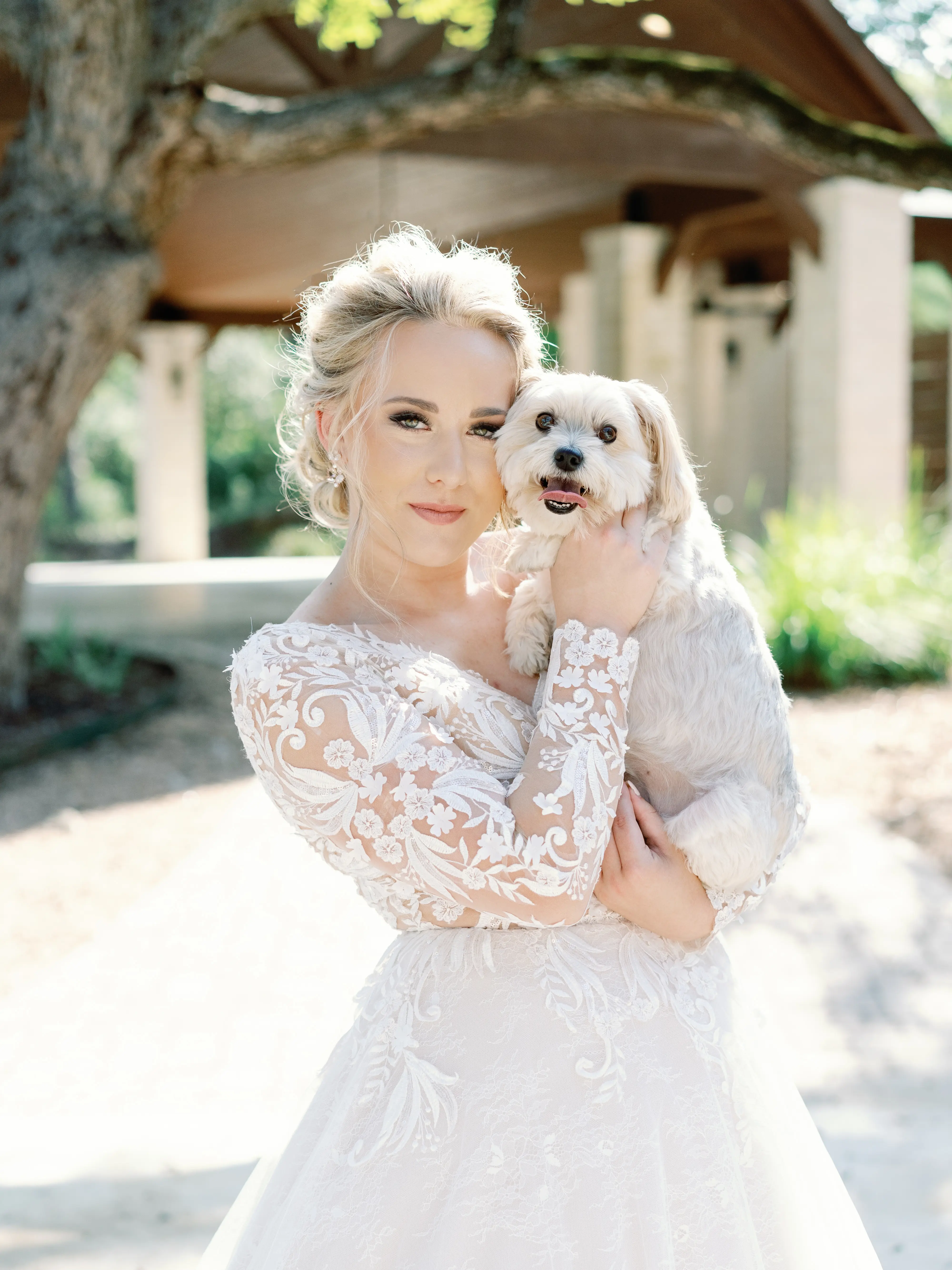 Real Bride Wearing Lace Ballgown Wedding Dress Called Zander By Sottero and Midgley Holding Her Dog
