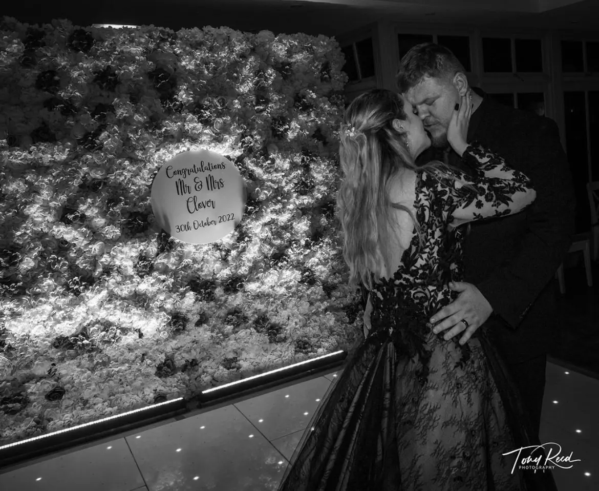Groom Kissing and Dancing With Bride In A Black Lace Long Sleeved Ball Gown Wedding Dress Named Zander By Sottero And Midgley