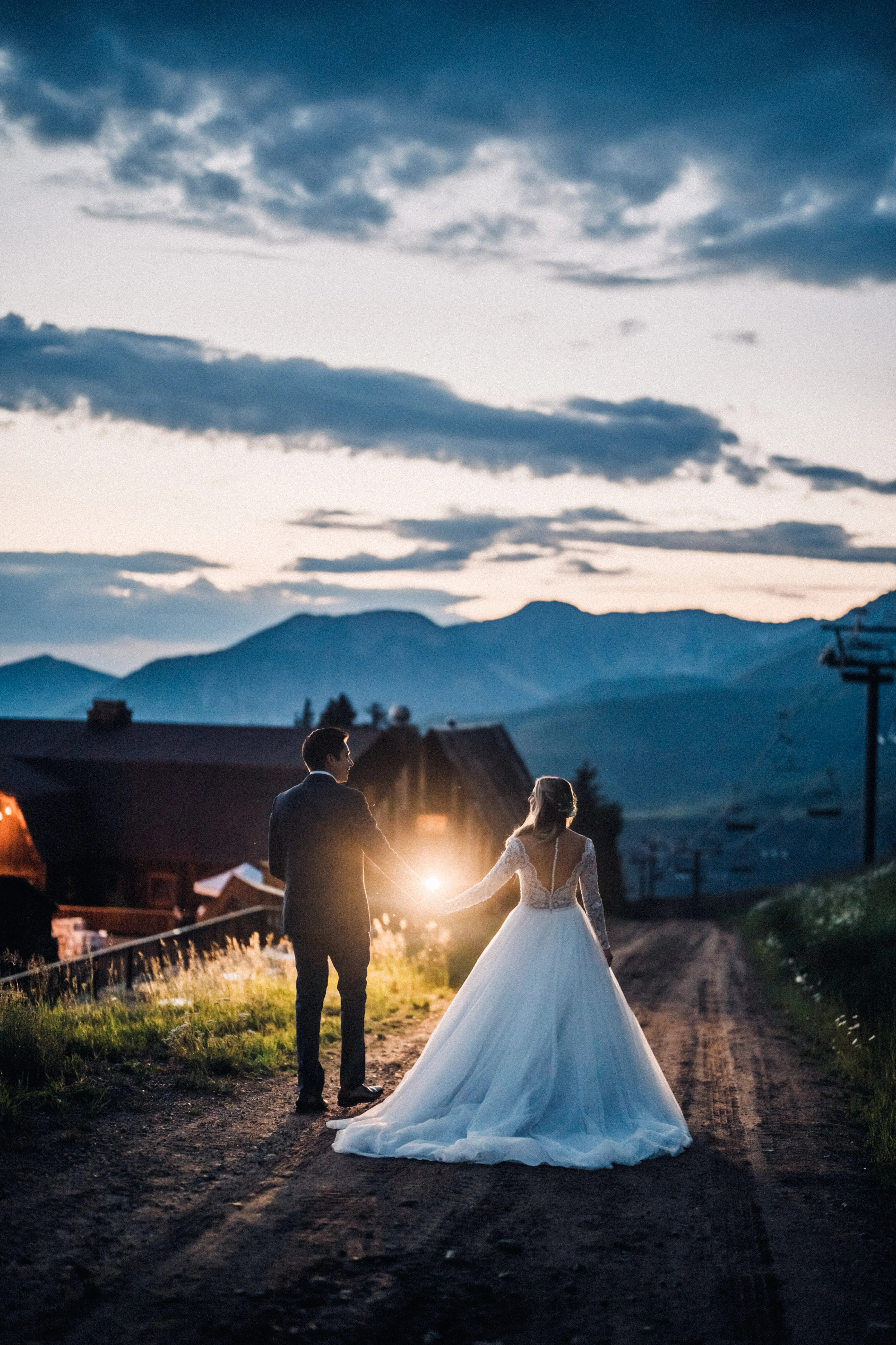 Bride with groom wearing long sleeve lace ballgown wedding dress