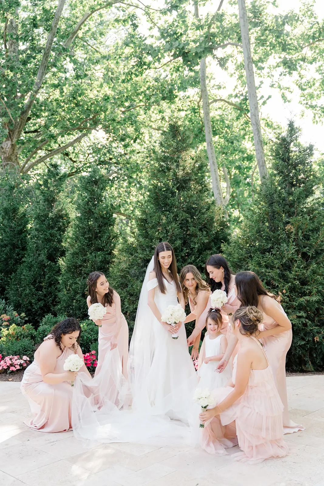 Bride wearing Anniston Lane by Maggie Sottero with her bridesmaids fixing her dress