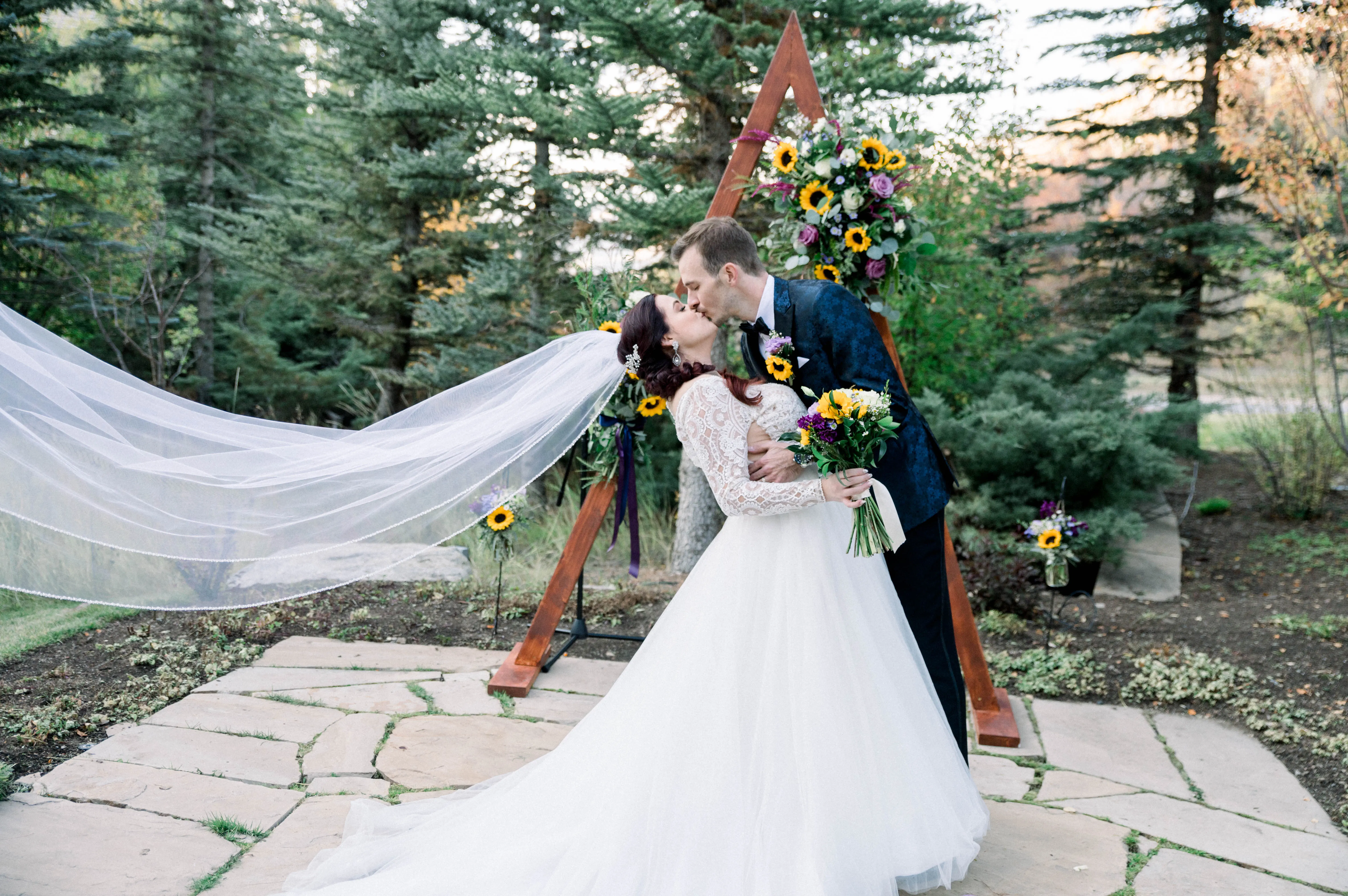 Bride Wearing Princess Wedding Dress Called Mallory Dawn By Maggie Sottero kissing the Groom