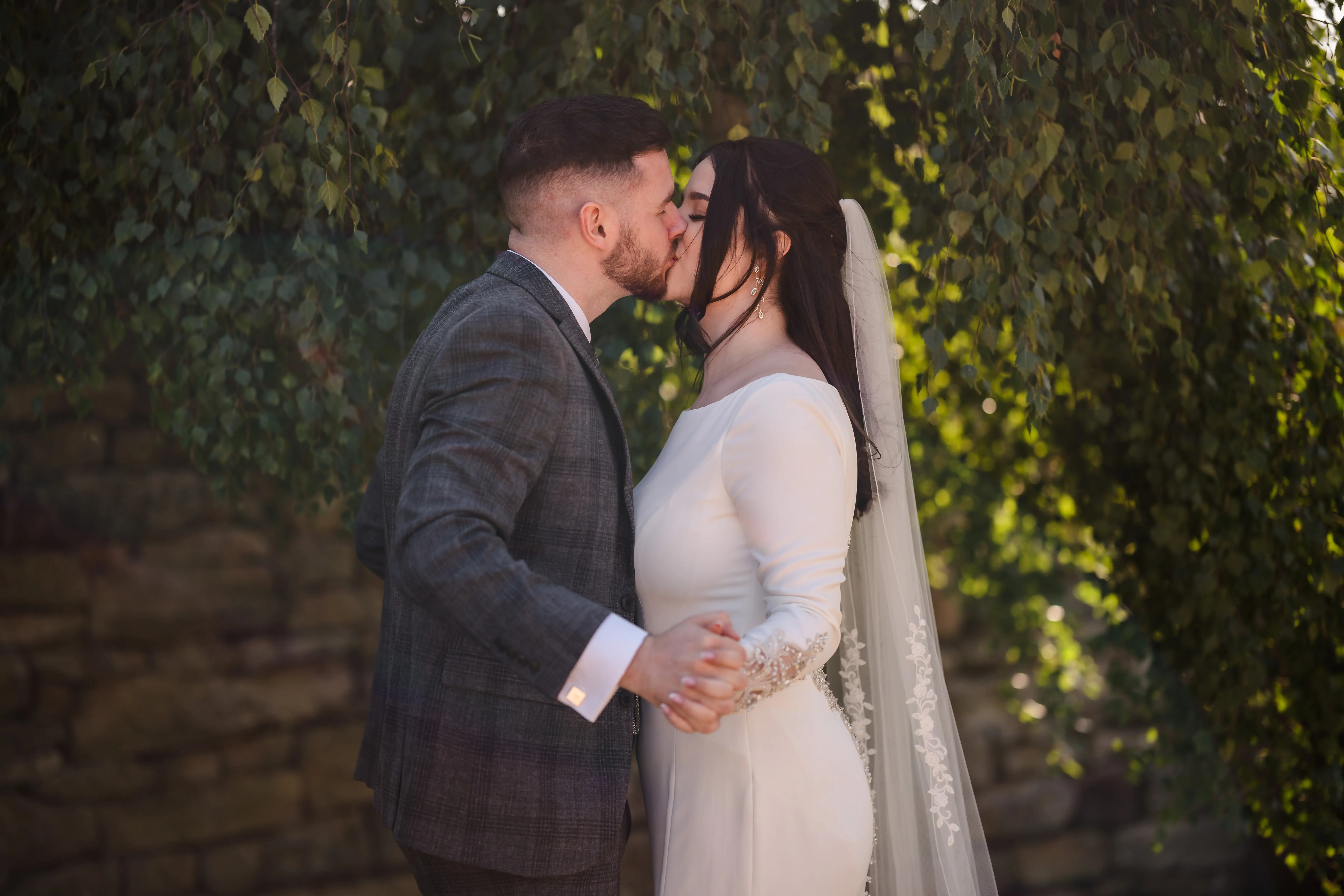 Bride Wearing Simple Keyhole Back Wedding Dress Called Aston By Sottero and Midgley Kissing Groom