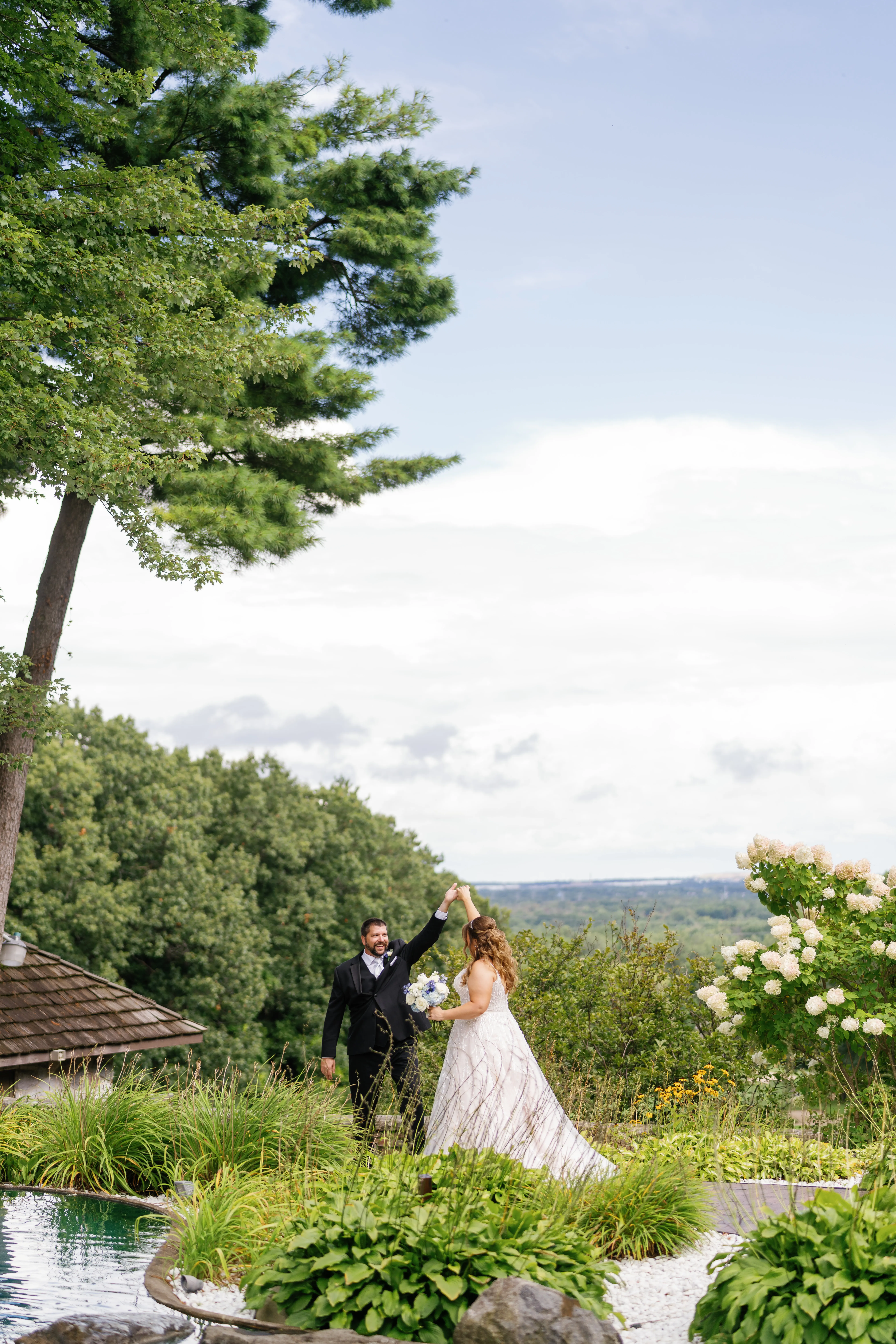 Bride Wearing Beaded Wedding Dress Called Marvine By Sottero And Midgley Dancing With Groom In A Garden