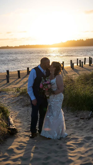 Bride Wearing Romantic Glam Lace Wedding Dress Called Tuscany Marie By Maggie Sottero On The Beach With Groom
