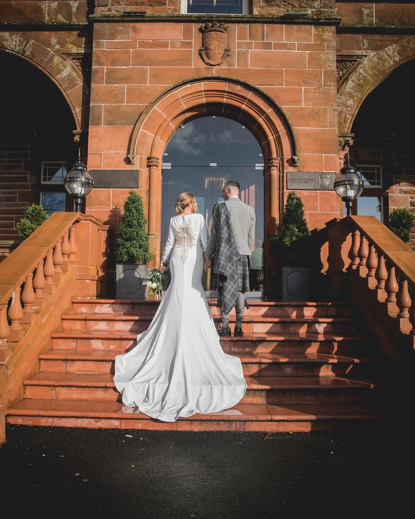 Groom with Bride in Crepe Fit-and-Flare Wedding Dress with Beaded Illusion Embroidery Featuring Swarovski Crystals Called Aston by Sottero & Midgley
