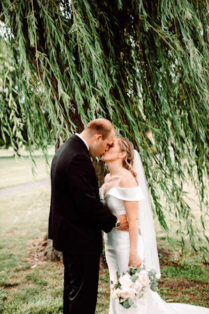 Groom kissing bride who is wearing wedding dress called Josie.