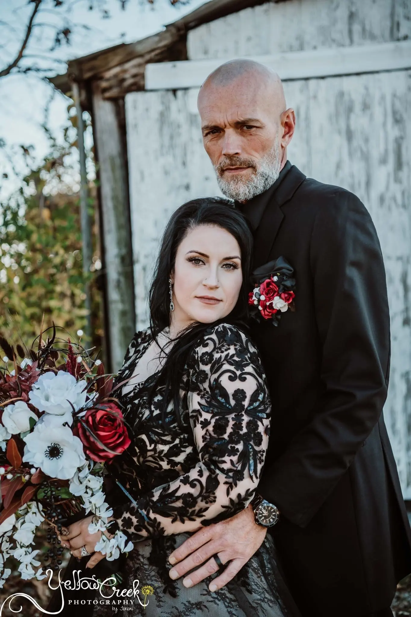 Bride And Groom Standing Together. Bride Wearing Chic Black Wedding Dress With Nature-Inspired Details Called Zander By Sottero And Midgley