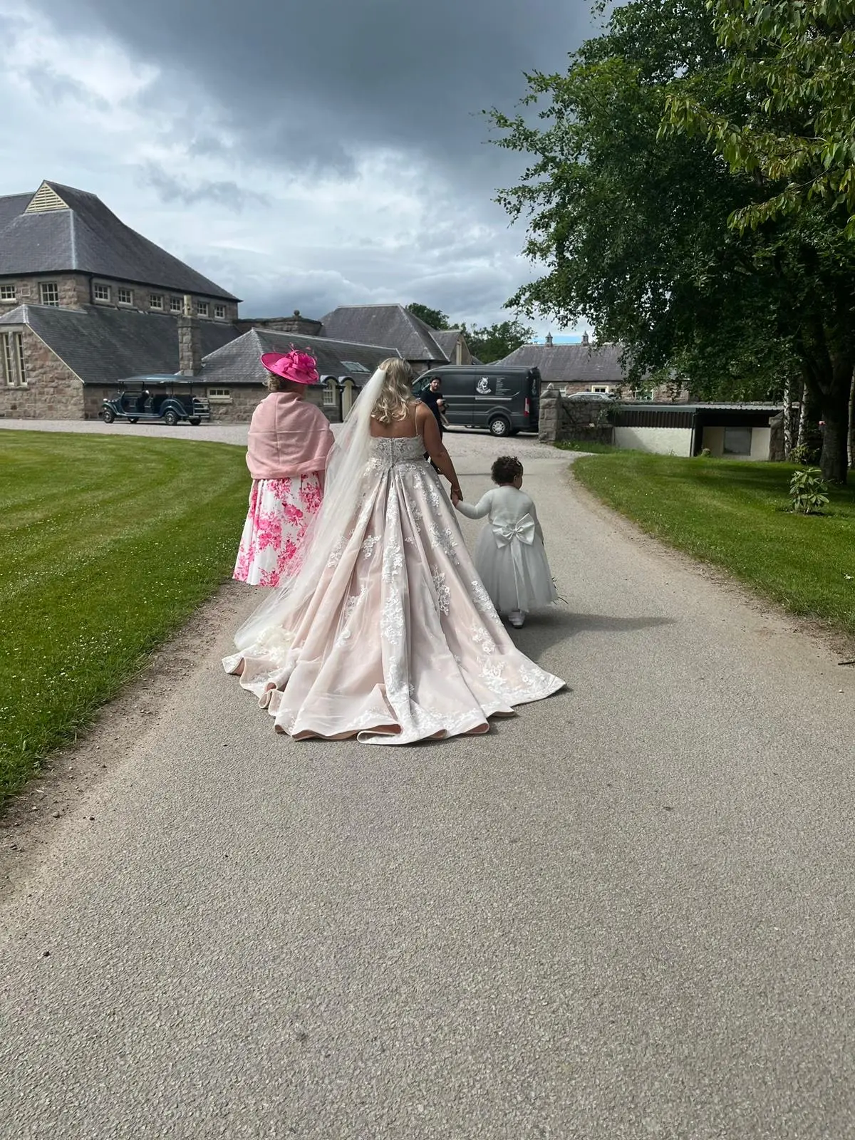 Bride wearing Norvinia by Sottero and Midgley walking with family