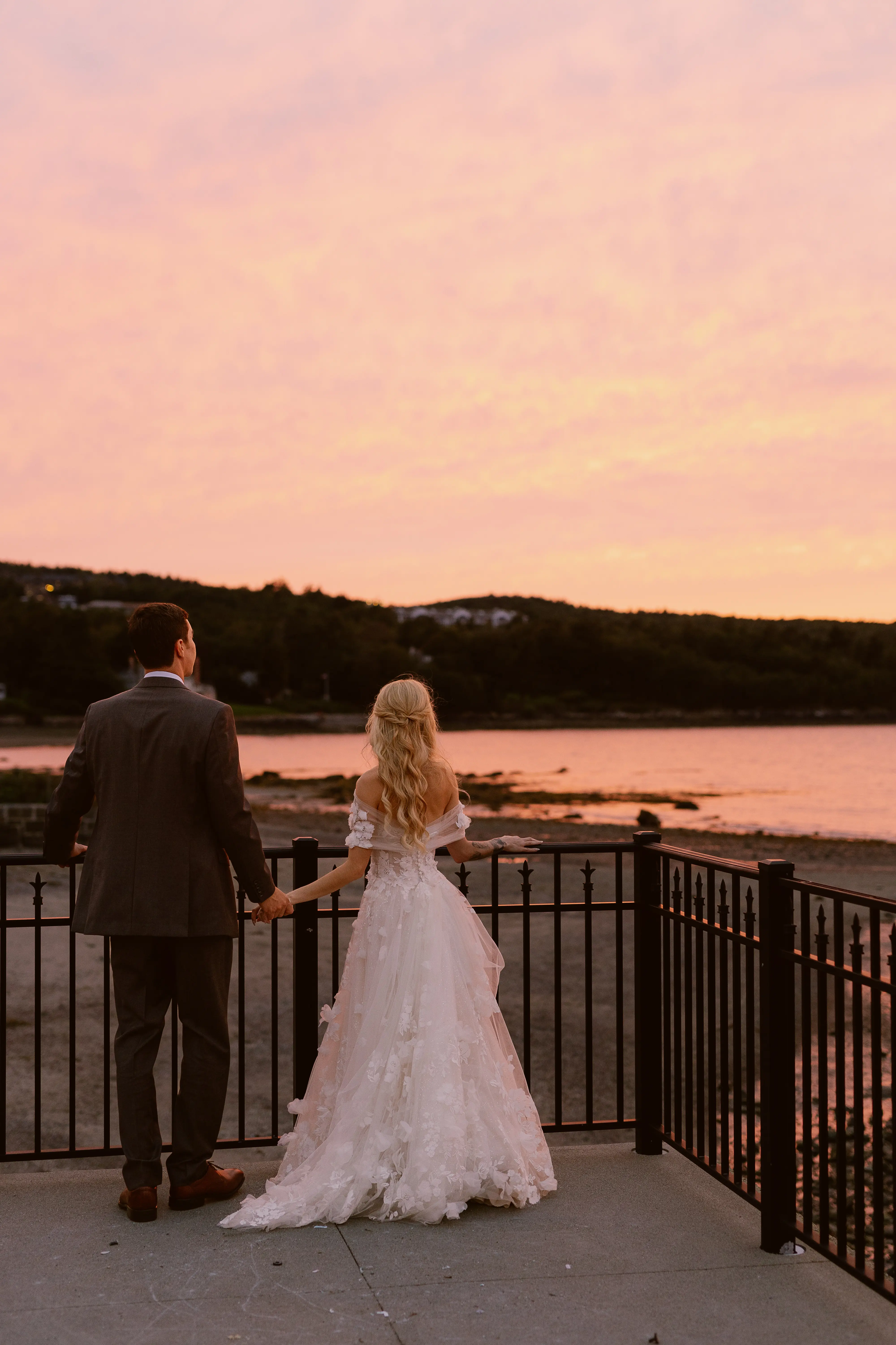 Bride wearing Laila wedding dress by Maggie Sottero standing with her husband