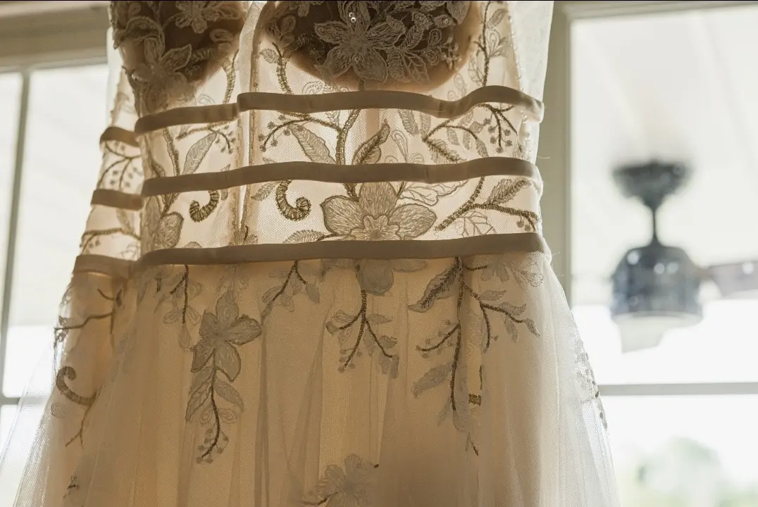 Details shining through the window of Boho Lace Wedding Dress called Raelynn by Rebecca Ingram