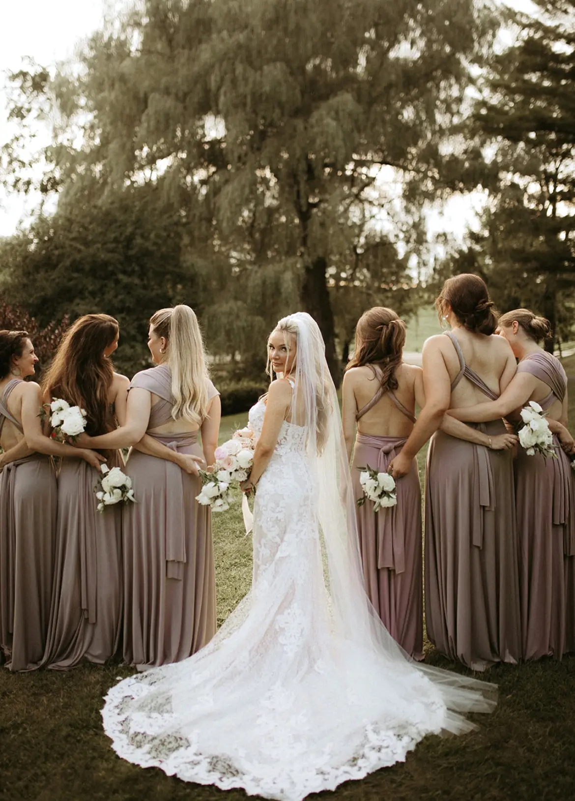 Bride wearing Lace Fit-and-Flare Wedding Dress called Tuscany Lynette by Maggie Sottero with her bridesmaids