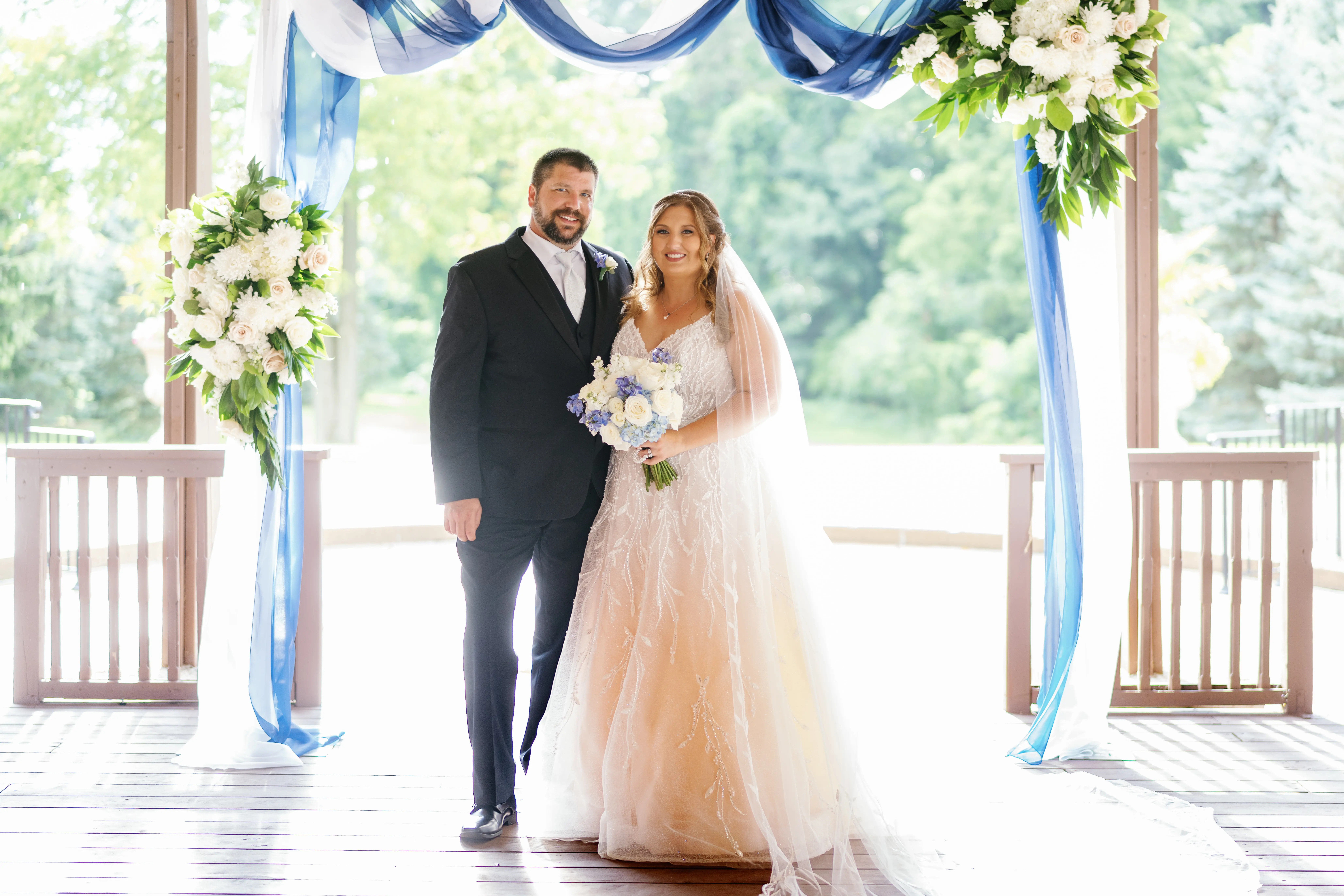 Bride Wearing Beaded Wedding Dress Called Marvine By Sottero And Midgley With Groom Holding A Bouquet