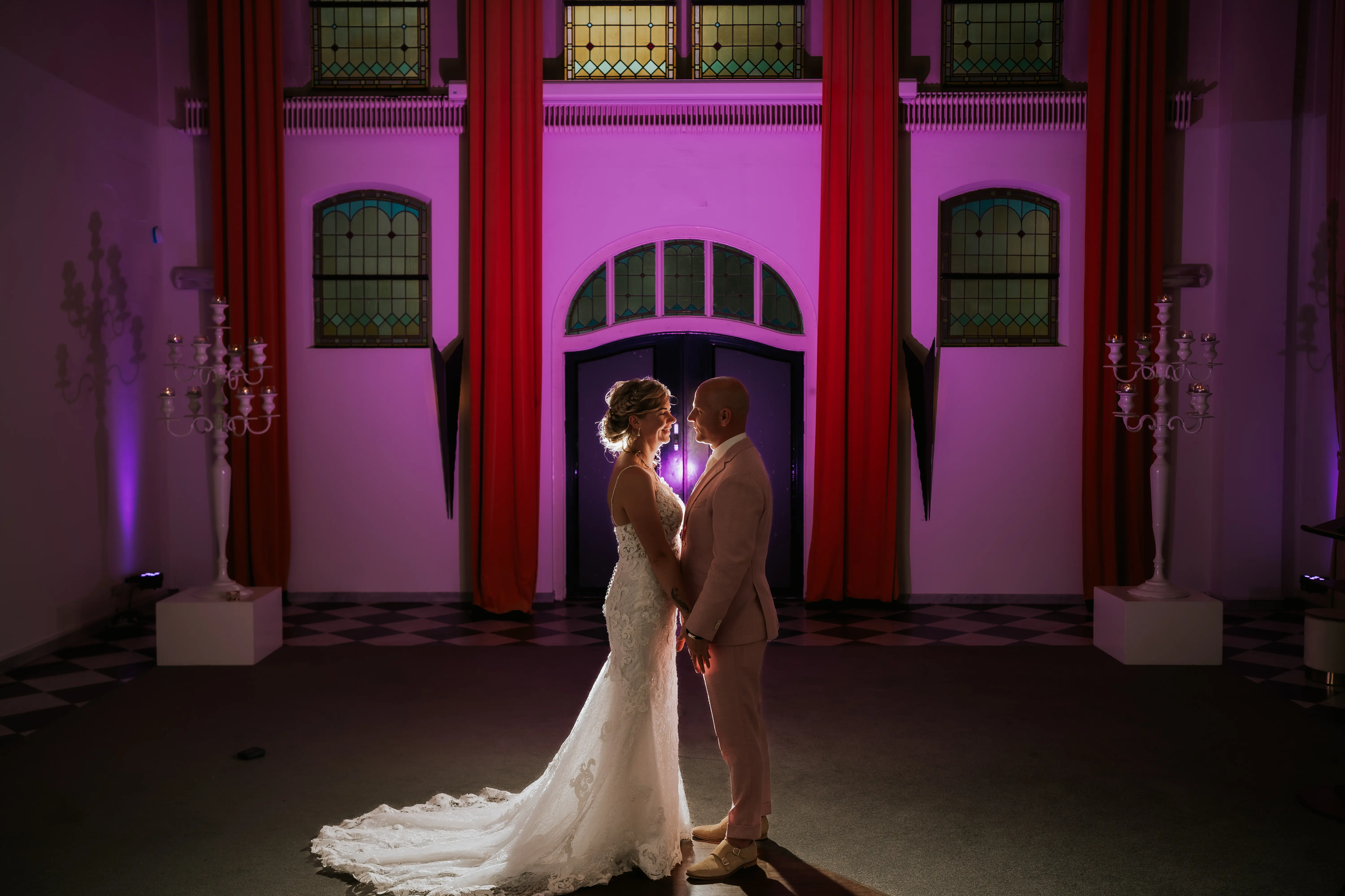 Bride wearing Tuscany Lynette by Maggie Sottero holding hands with her husband