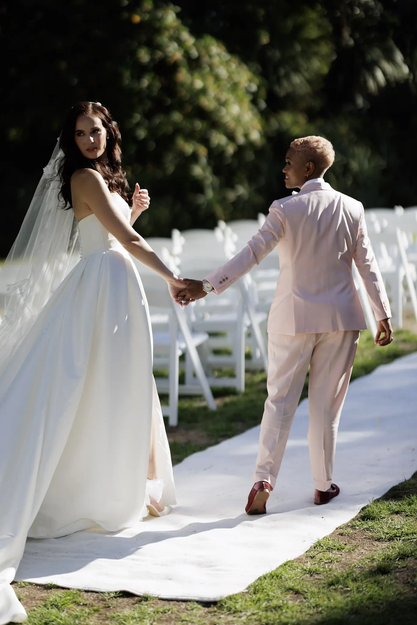 Bride wearing Aspen by Sottero and Midgley holding hands with her partner